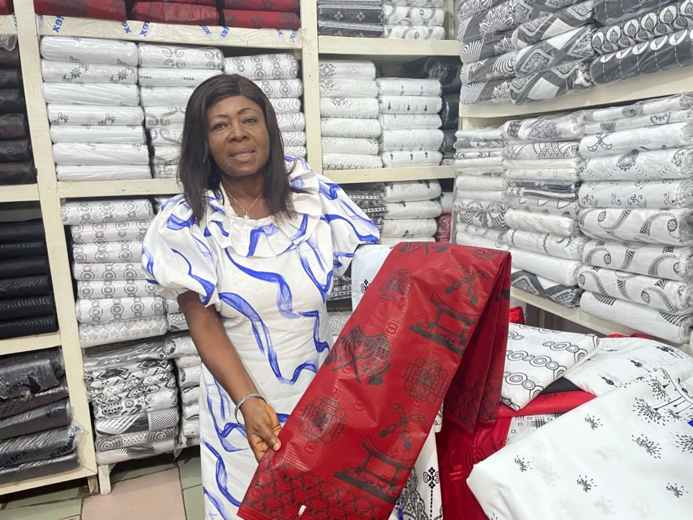 Comfort Boaehene displays traditional attire at her store in Makola market in central Accra, Ghana on June 12, 2023