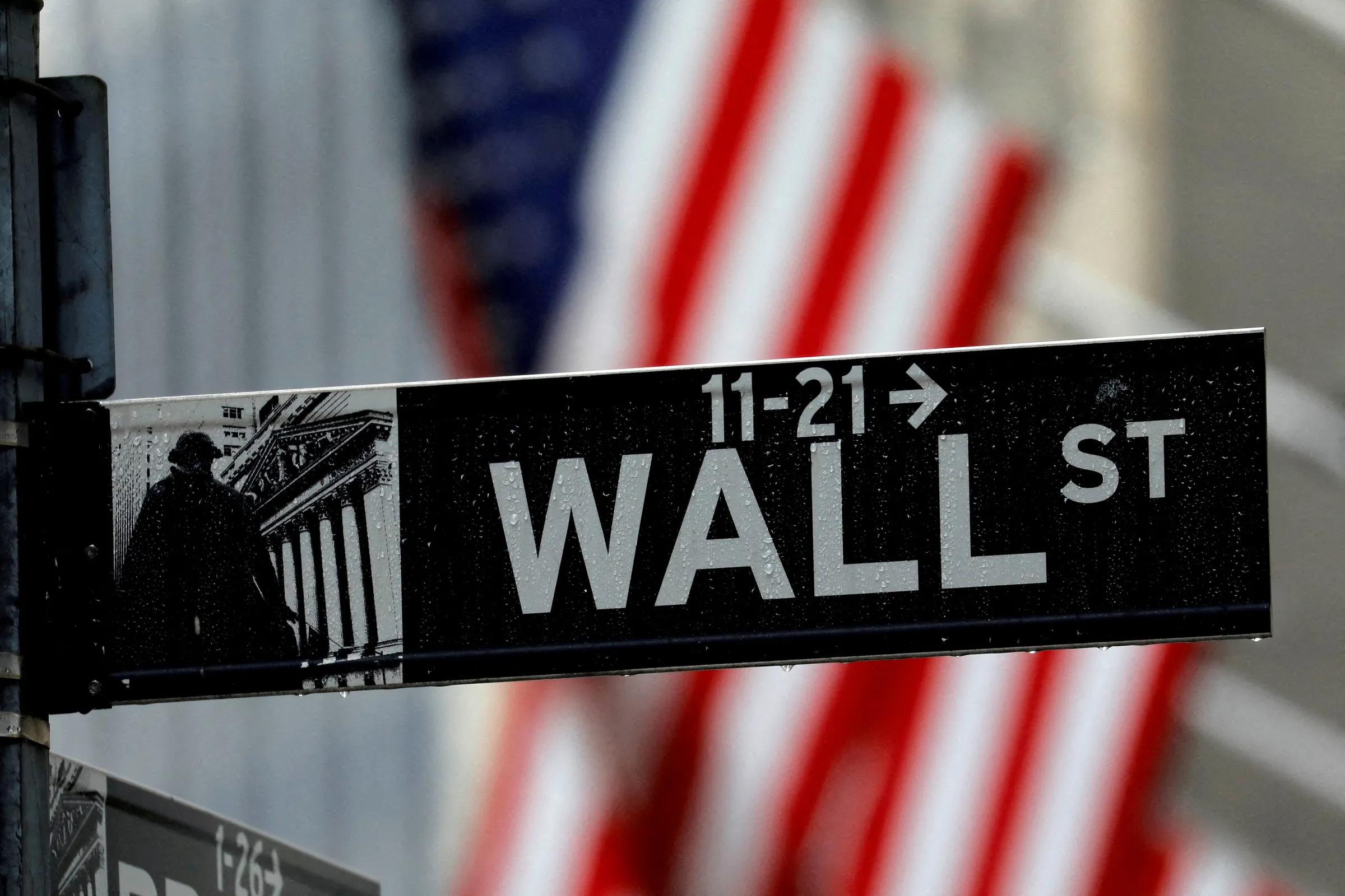 Raindrops hang on a sign for Wall Street outside the New York Stock Exchange in Manhattan in New York City, New York, U.S., October 26, 2020. REUTERS/Mike Segar