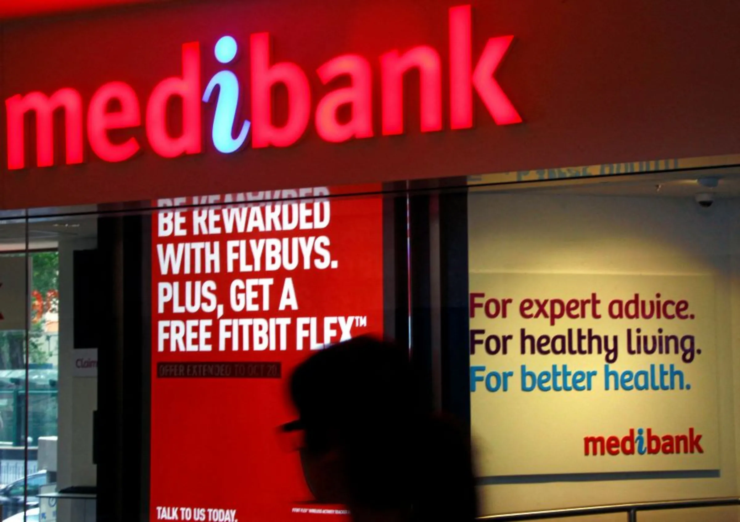 A woman walks past a branch of the Australian health insurer Medibank Private in Sydney October 20, 2014