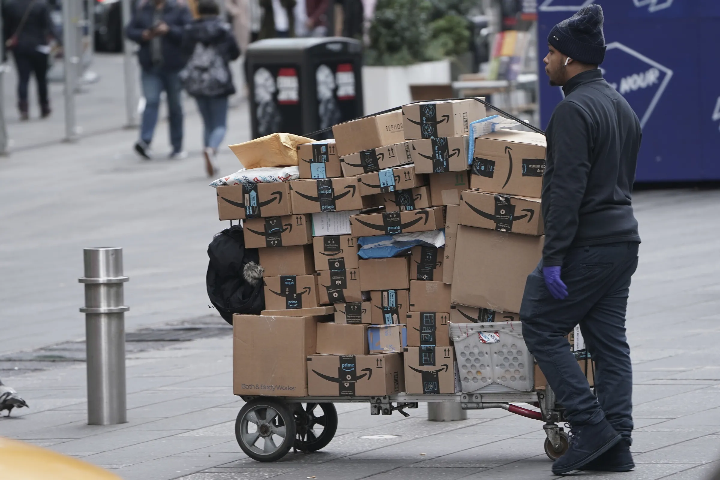 An Amazon delivery person walks in Times Square following the outbreak of Coronavirus disease (COVID-19), in the Manhattan borough of New York City, New York, U.S., March 17, 2020. REUTERS/Carlo Allegri