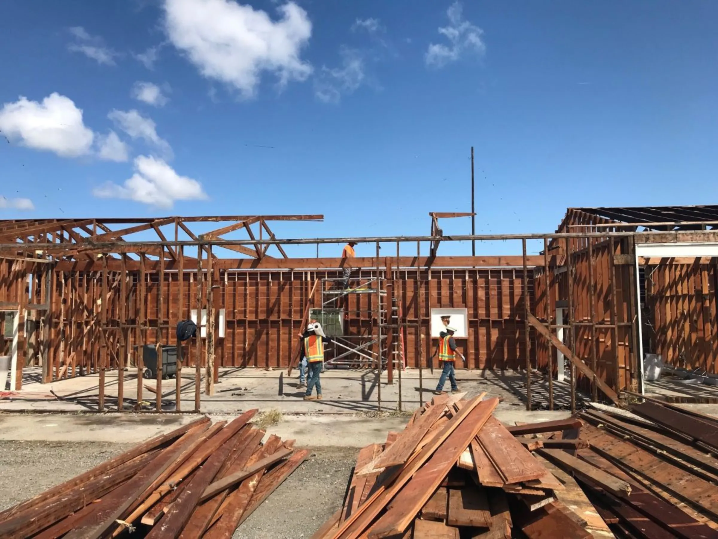 Workers take apart a commercial building as part of a deconstruction project in Palo Alto, California, in 2019. Zero Waste Palo Alto/Handout via Thomson Reuters Foundation