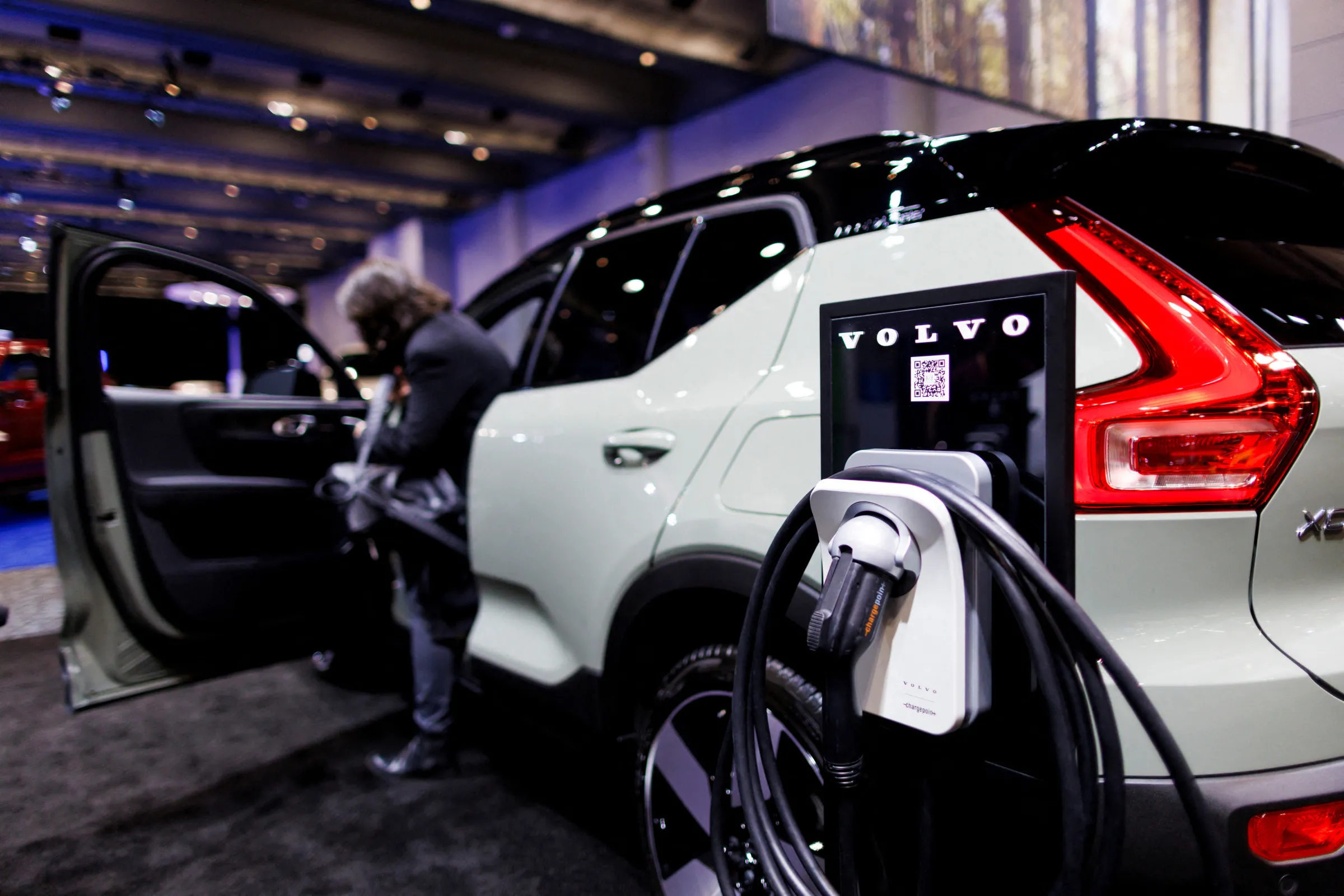 An EV charger next to a Volvo car at the Canadian International Auto Show in Toronto, Ontario, Canada February 15, 2024. REUTERS/Cole Burston