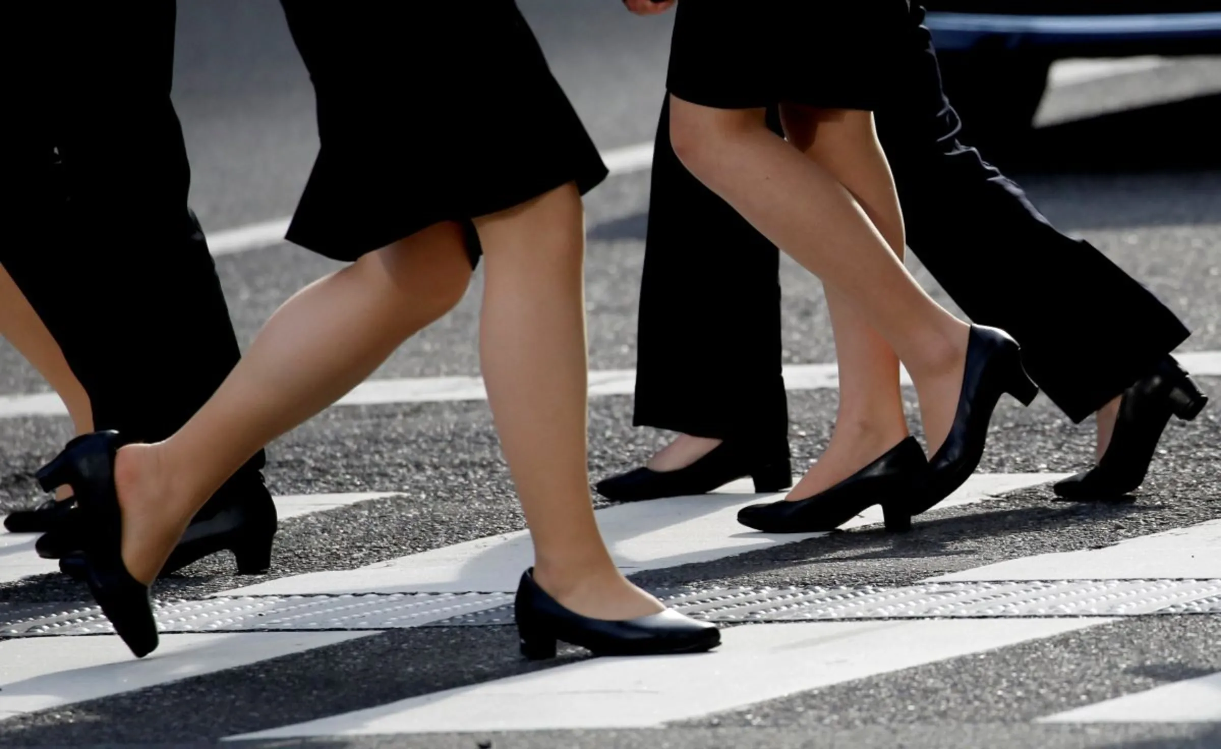 Women in high heels walk at a business district in Tokyo, Japan, June 4, 2019. REUTERS/Kim Kyung-Hoon