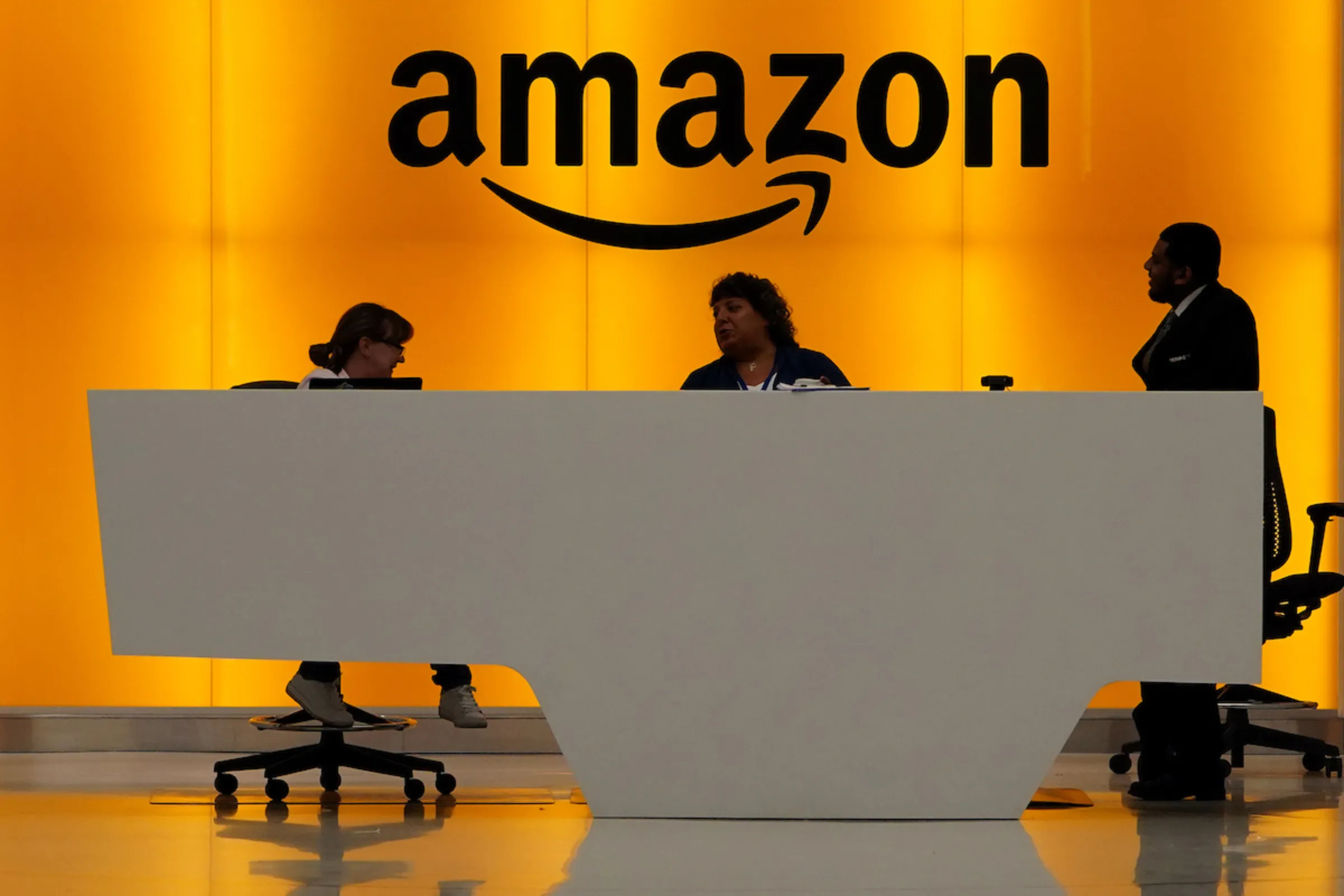 Staff chat at the front desk of the Amazon office in the Manhattan borough of New York, New York, U.S., May 1, 2019. REUTERS/Carlo Allegri