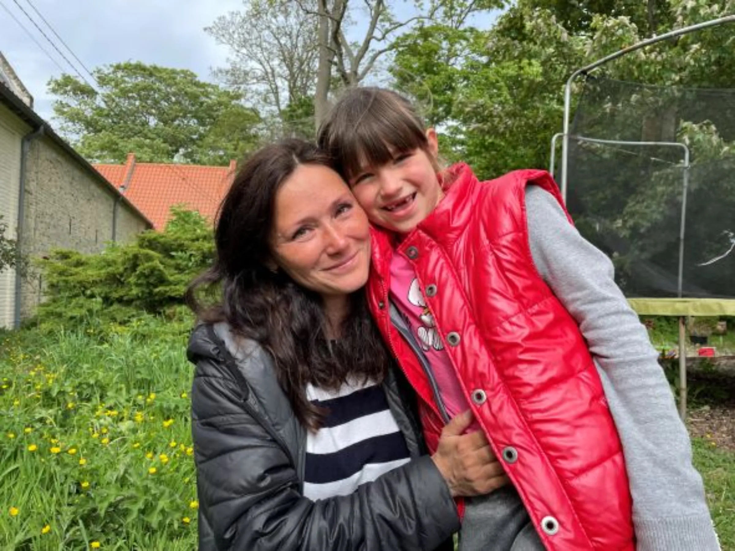 Yulia Ostrovksa and daughter Veronika, 7, at the farm in Tilques, May 10, 2022. Thomson Reuters Foundation/Emma Batha