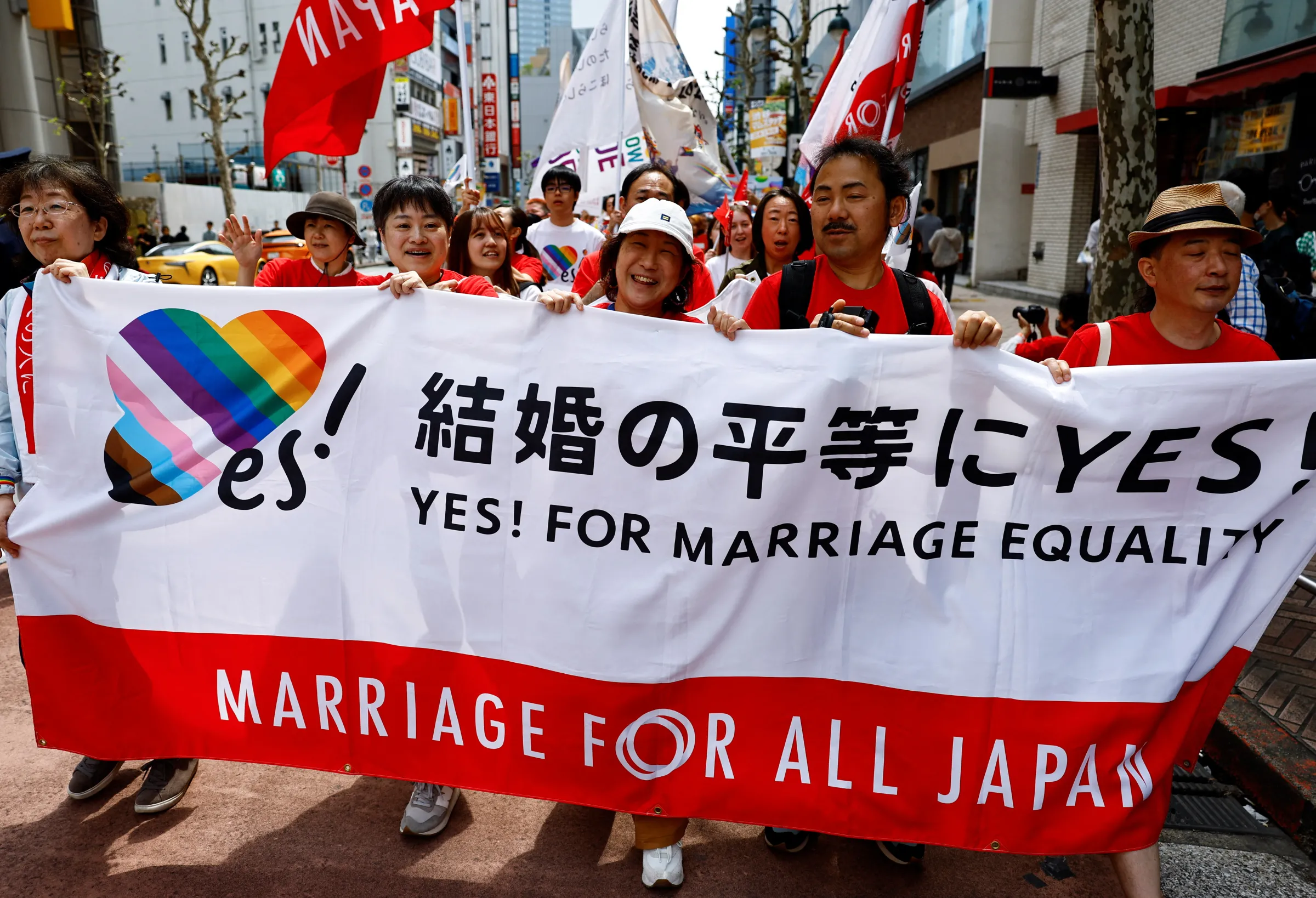 Participants hold a banner, as they march during the Tokyo Rainbow Pride parade, celebrating advances in LGBTQ+ rights and calling for marriage equality, in Tokyo, Japan April 21, 2024. REUTERS/Issei Kato