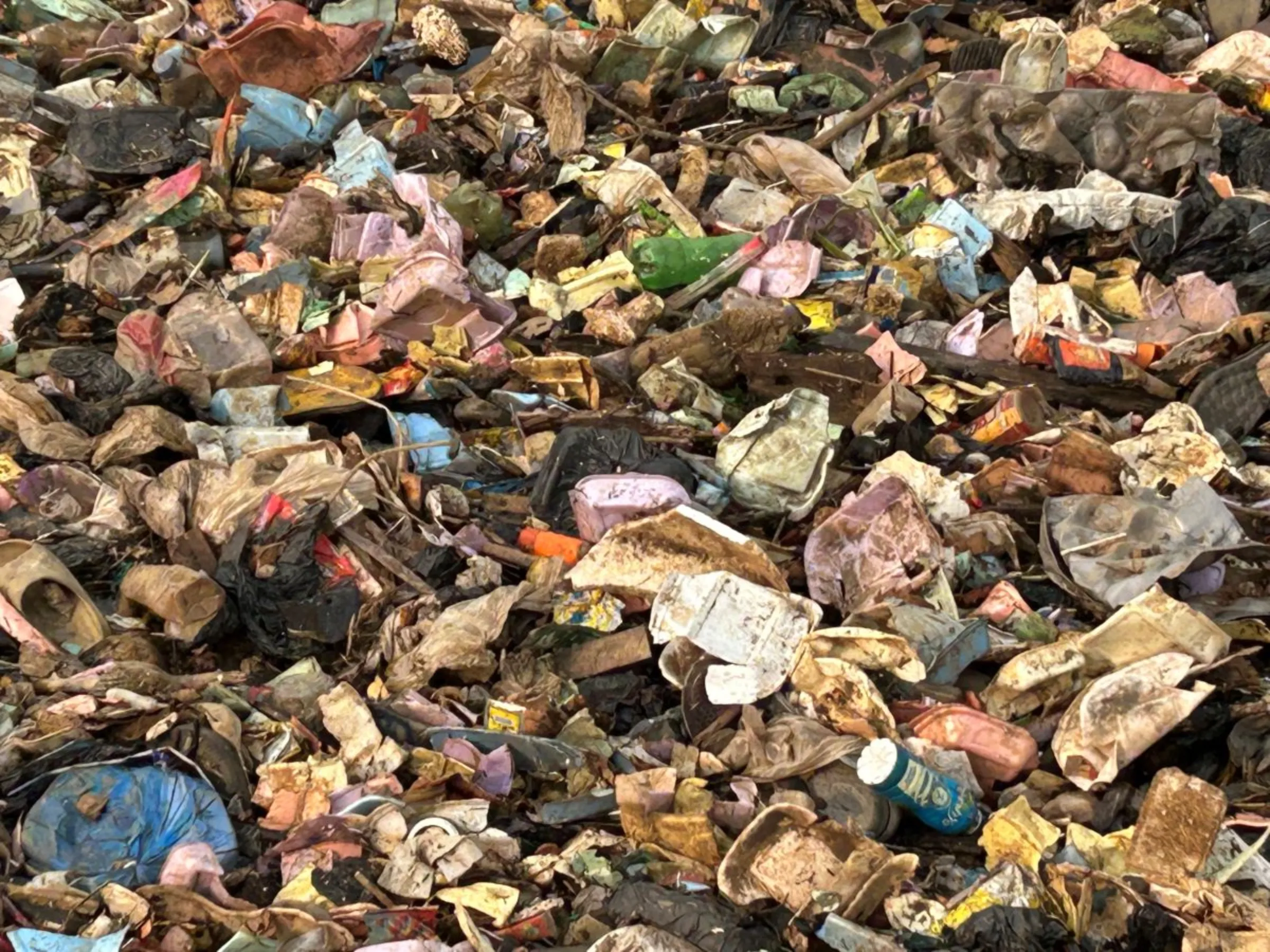 Used plastics and waste block a canal in Lagos district on February 20, 2024. Bukola Adebayo/ Thomson Reuters Foundation