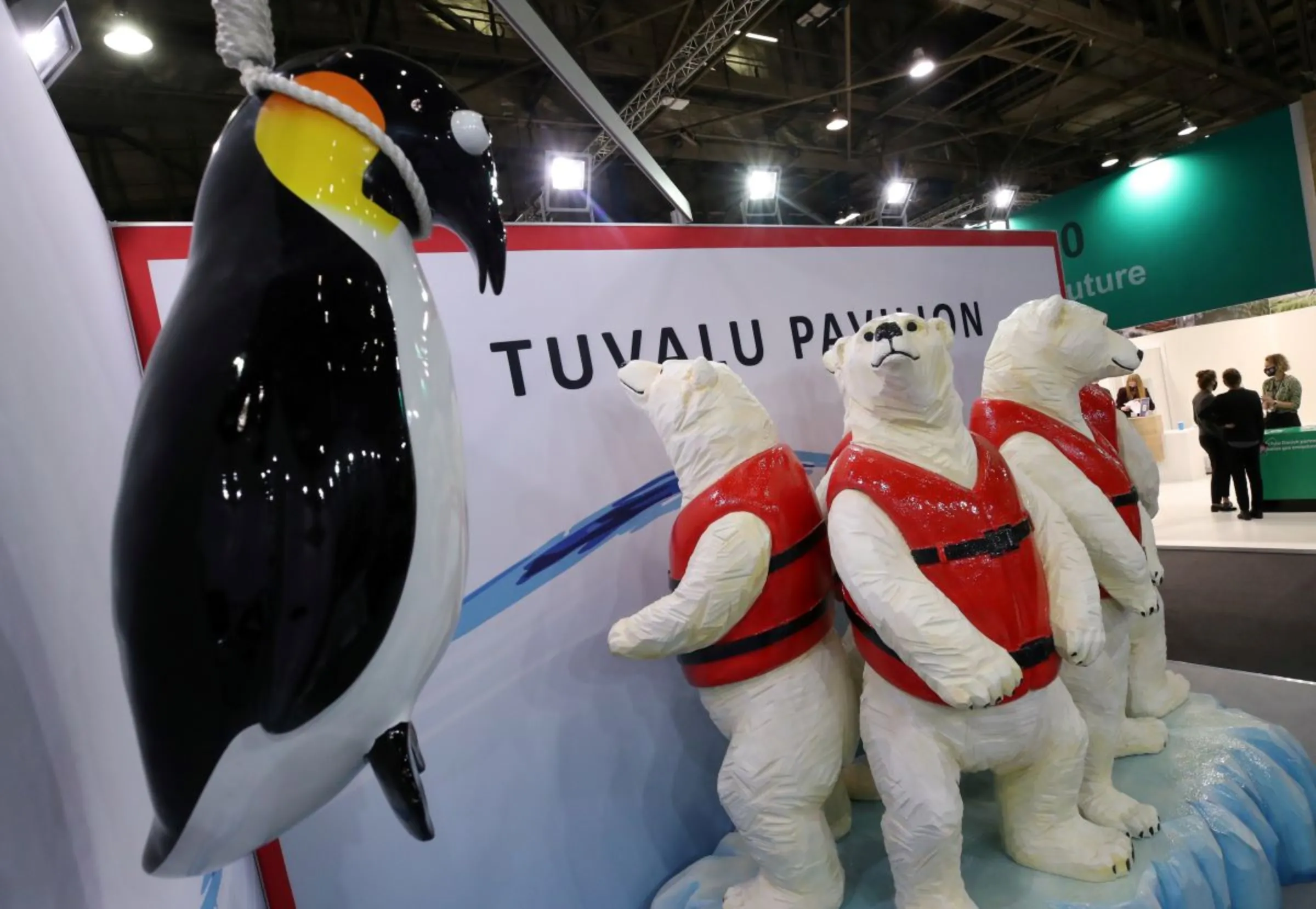 People stand next to the Tuvalu pavilion during the UN Climate Change Conference (COP26) in Glasgow, Scotland, Britain, November 1, 2021. REUTERS/Yves Herman