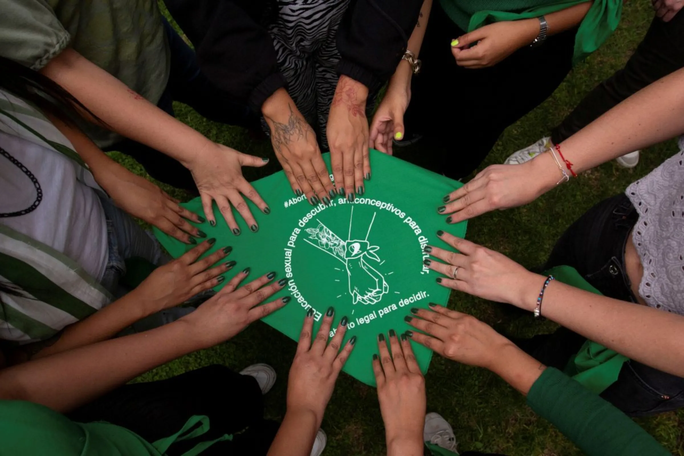 People hold a green handkerchief as members of the Information Group on Reproductive Choice (GIRE) organization gather to celebrate days after the Supreme Court declared it unconstitutional for the federal government to criminalize abortion, in Mexico City, Mexico, September 13, 2023