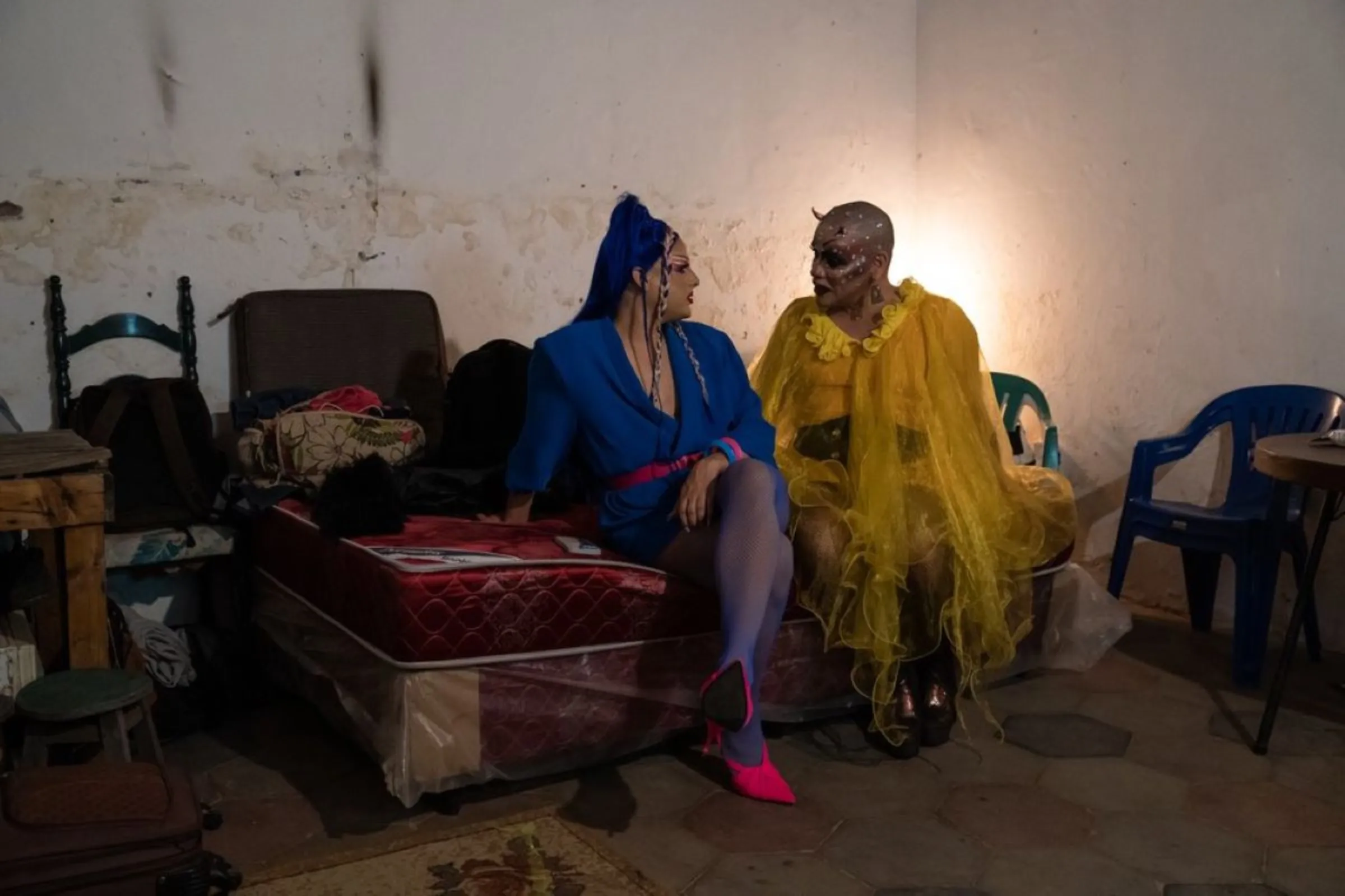 Dislexia Severa (left) and Envidia Metenes (right), two different generations of Paraguayan drag queens, talk together backstage at Envidia’s birthday celebration at Literaity, a cultural centre in Asunción, Paraguay, February 22, 2023