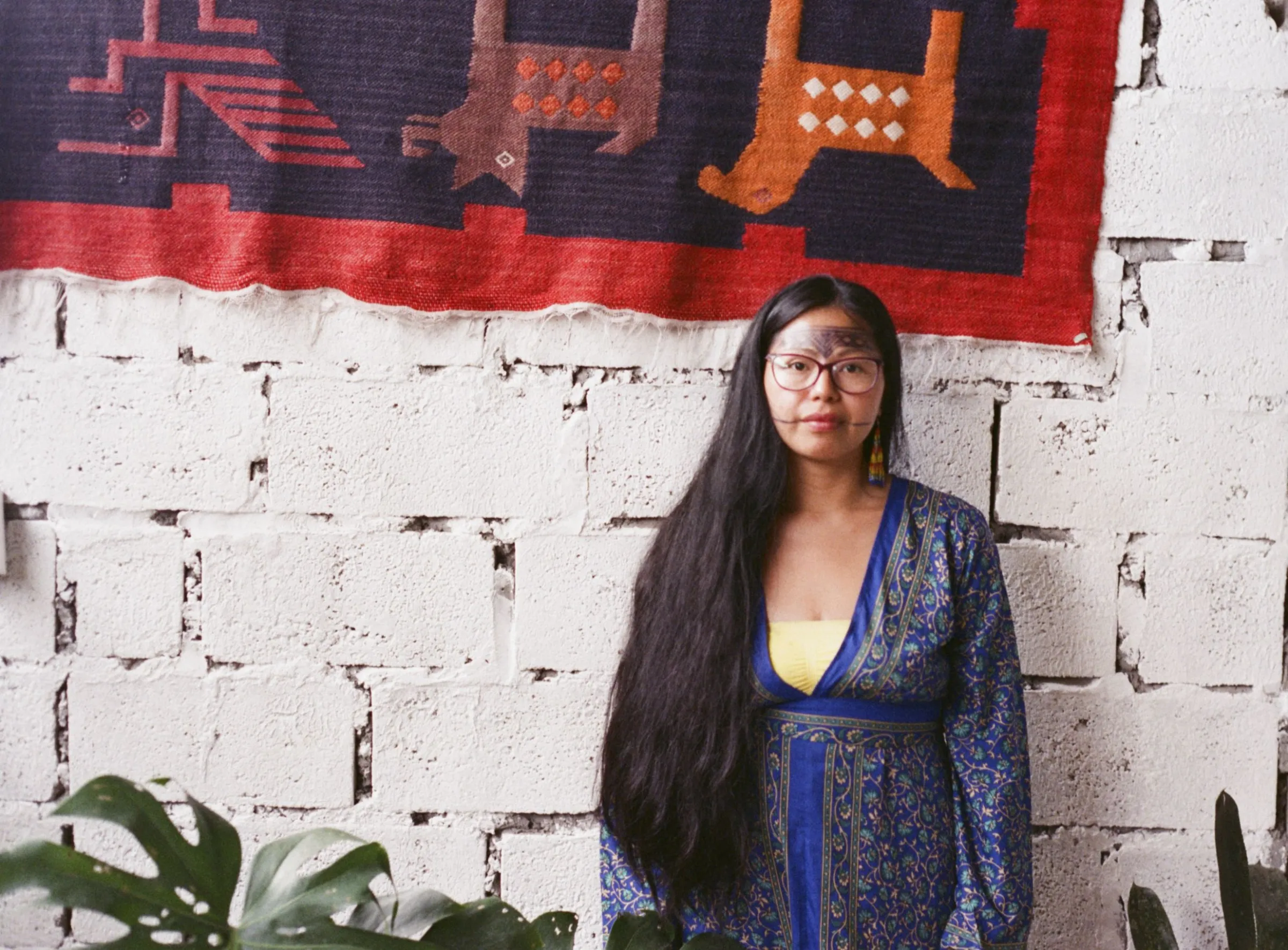 Itaya Andy, an Indigenous healer from the Sarayaku community, stands in the Casa de Mujeres Amazónicas