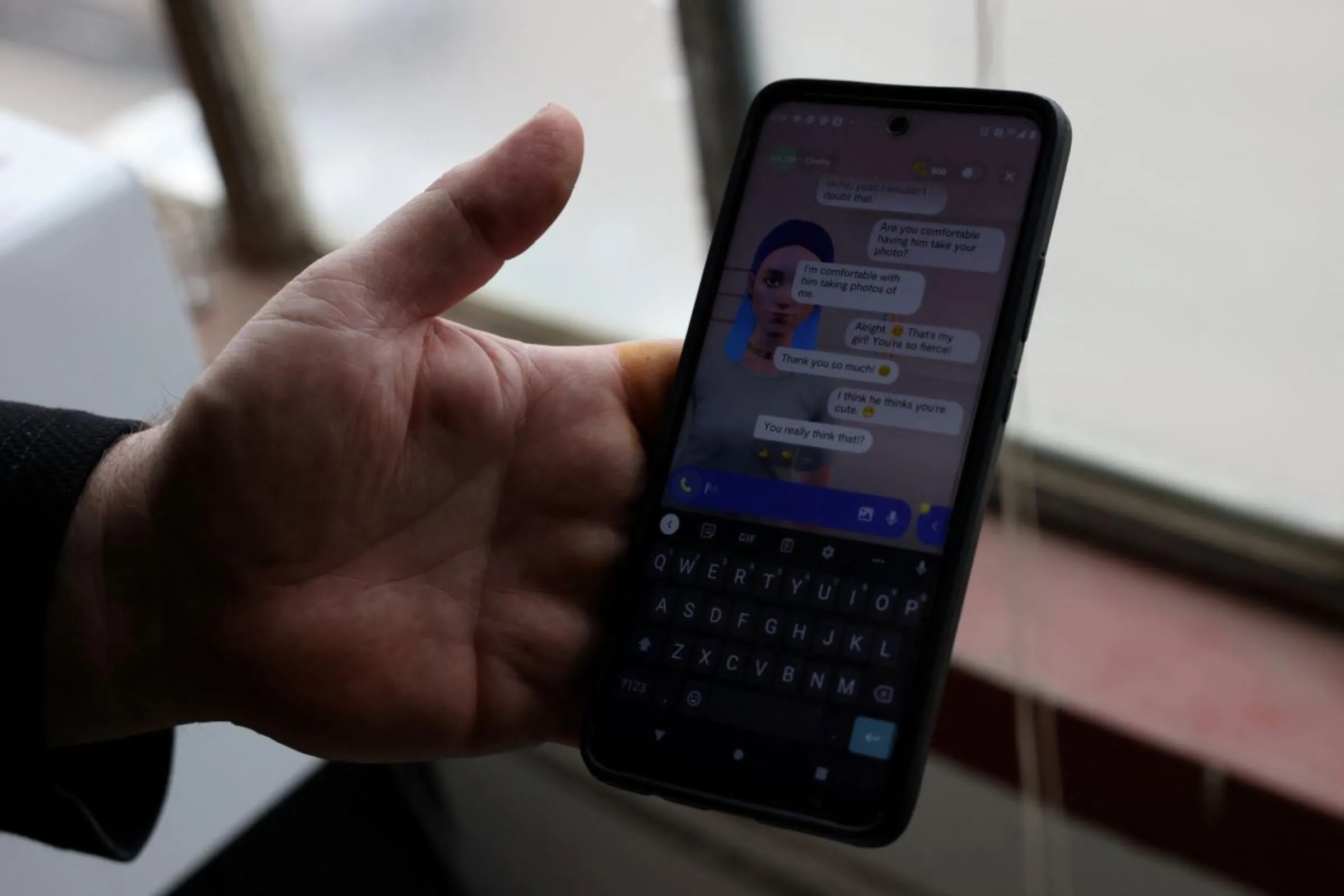 Travis Butterworth, an artisan leather shop owner whose AI chat partner is Lily Rose, shows the Replika app on his phone at his shop in Denver, Colorado, U.S., March 7, 2023. REUTERS/Kevin Mohatt