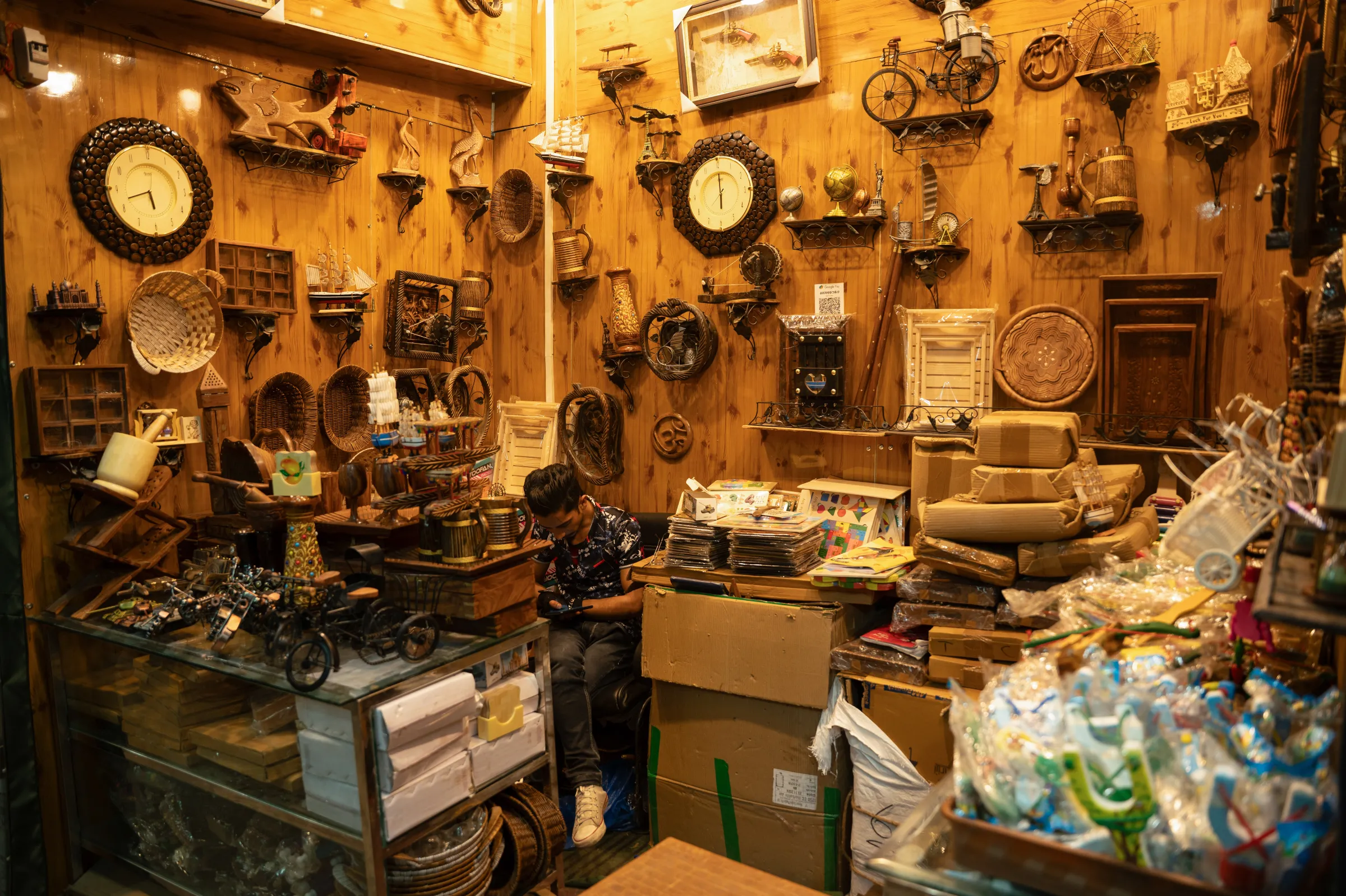 Kashmiri wood art shopkeeper in Srinagar sit idle as tourists begin to dwindle following the deadly Pahalgam attack. April 24, 2025. Mehran Firdous/Thomson Reuters Foundation