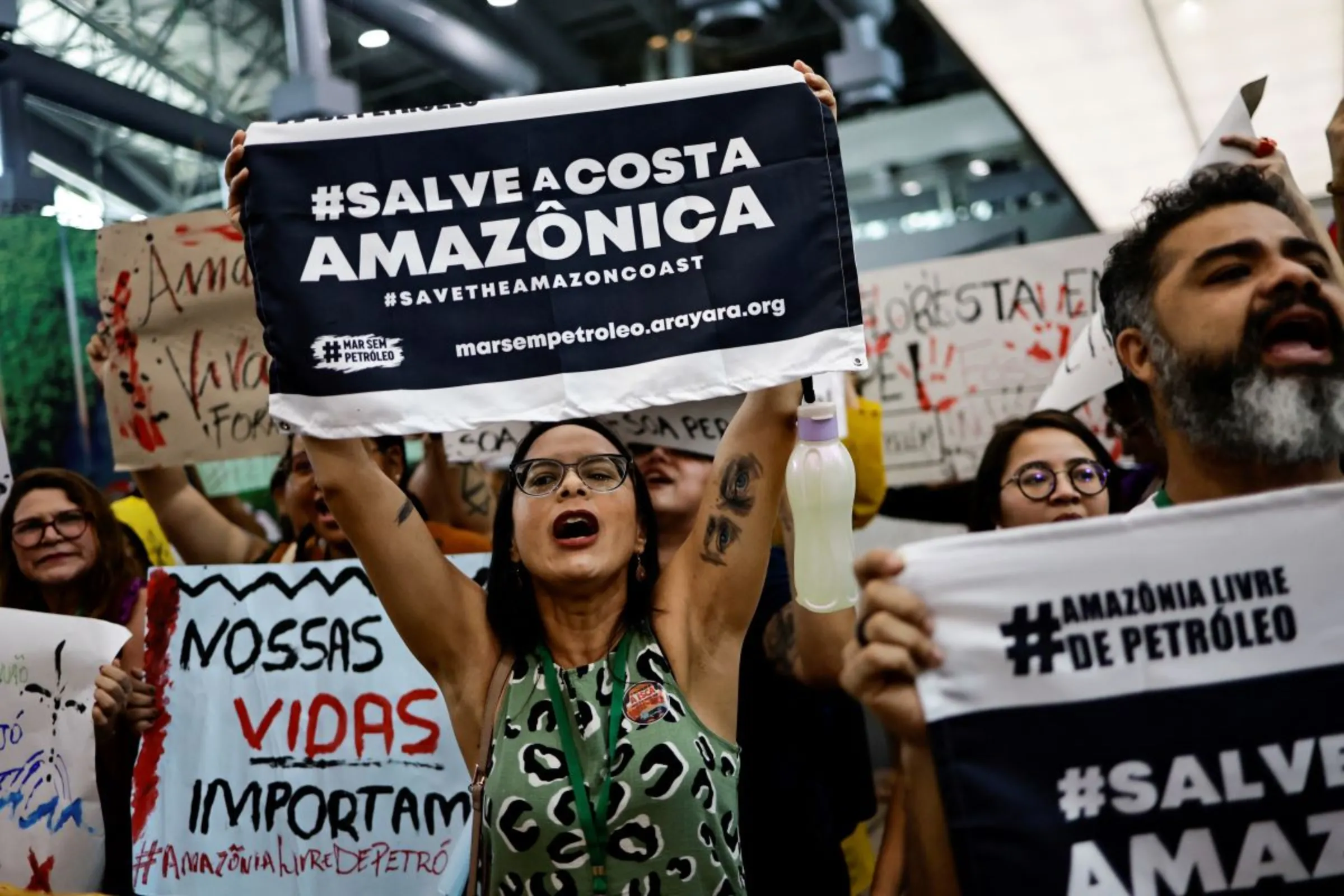 Members of social movements protest against oil exploration in the Amazon, inside the convention center where the Amazon Dialogues Seminar takes place, before a summit of Amazon rainforest nations in Belem, Para state, Brazil August 6, 2023