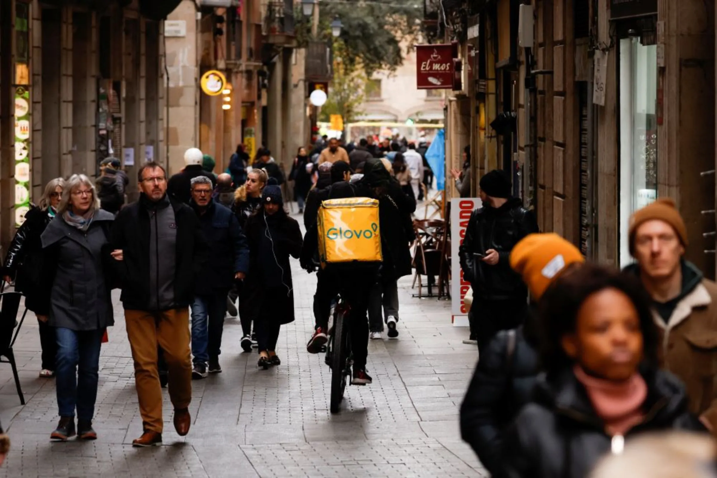 A Glovo delivery rider passes by a pedestrian area in Barcelona, Spain, January 24, 2023. REUTERS/Albert Gea