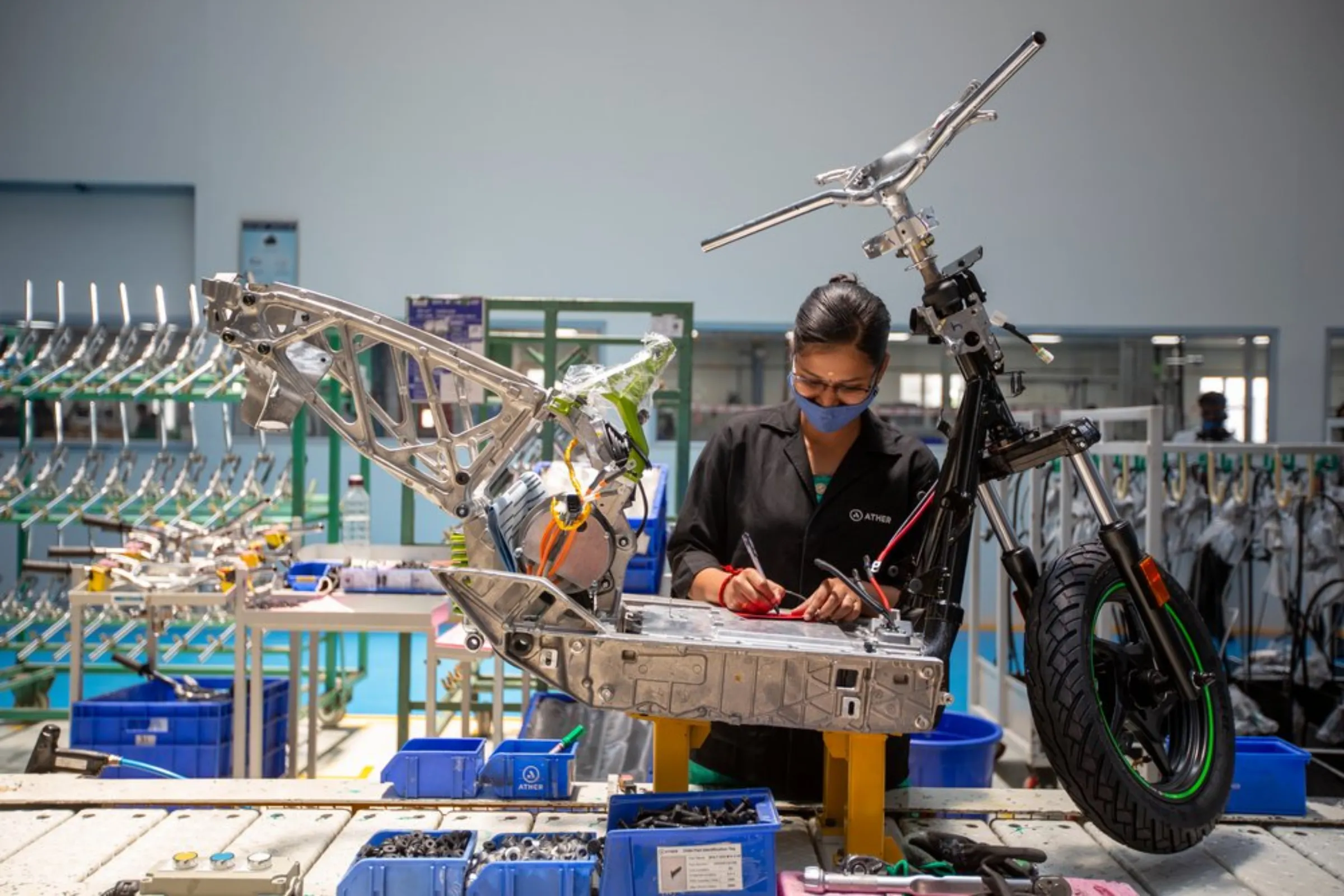 Workers assemble electric scooters at the Ather Energy factory in Hosur, India, April 20, 2022