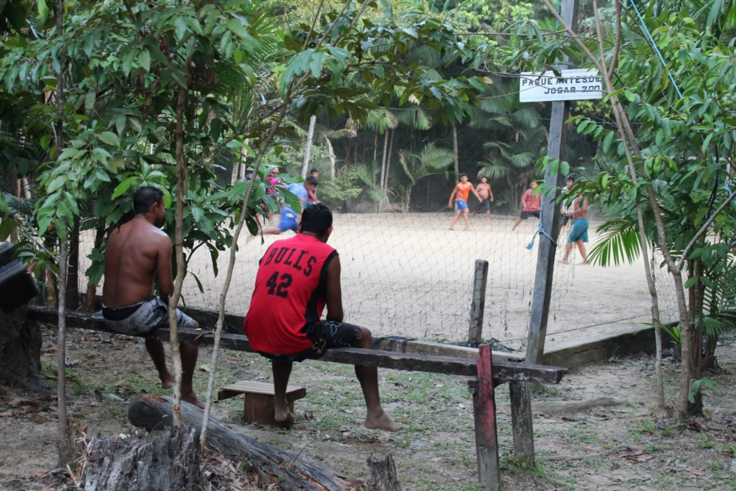 Boys play soccer on Caripetuba Island in Brazil's Amazon Basin, on August 10, 2023. Residents in the region are fighting a planned Cargill grain export terminal, saying the company was wrongly sold land from a protected reserve. Thomson Reuters Foundation /André Cabette Fábio