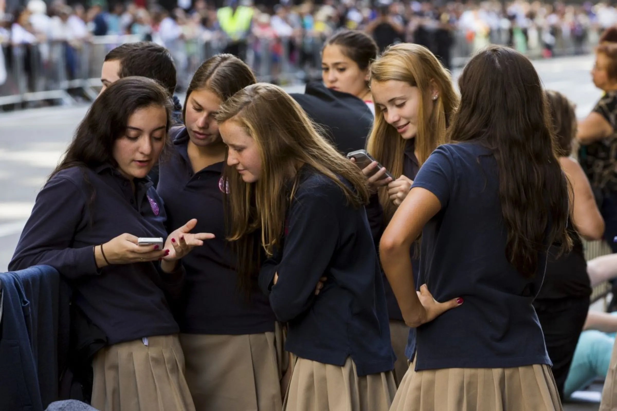 A group of school girls look at their phones in New York September 24, 2015. REUTERS/Lucas Jackson
