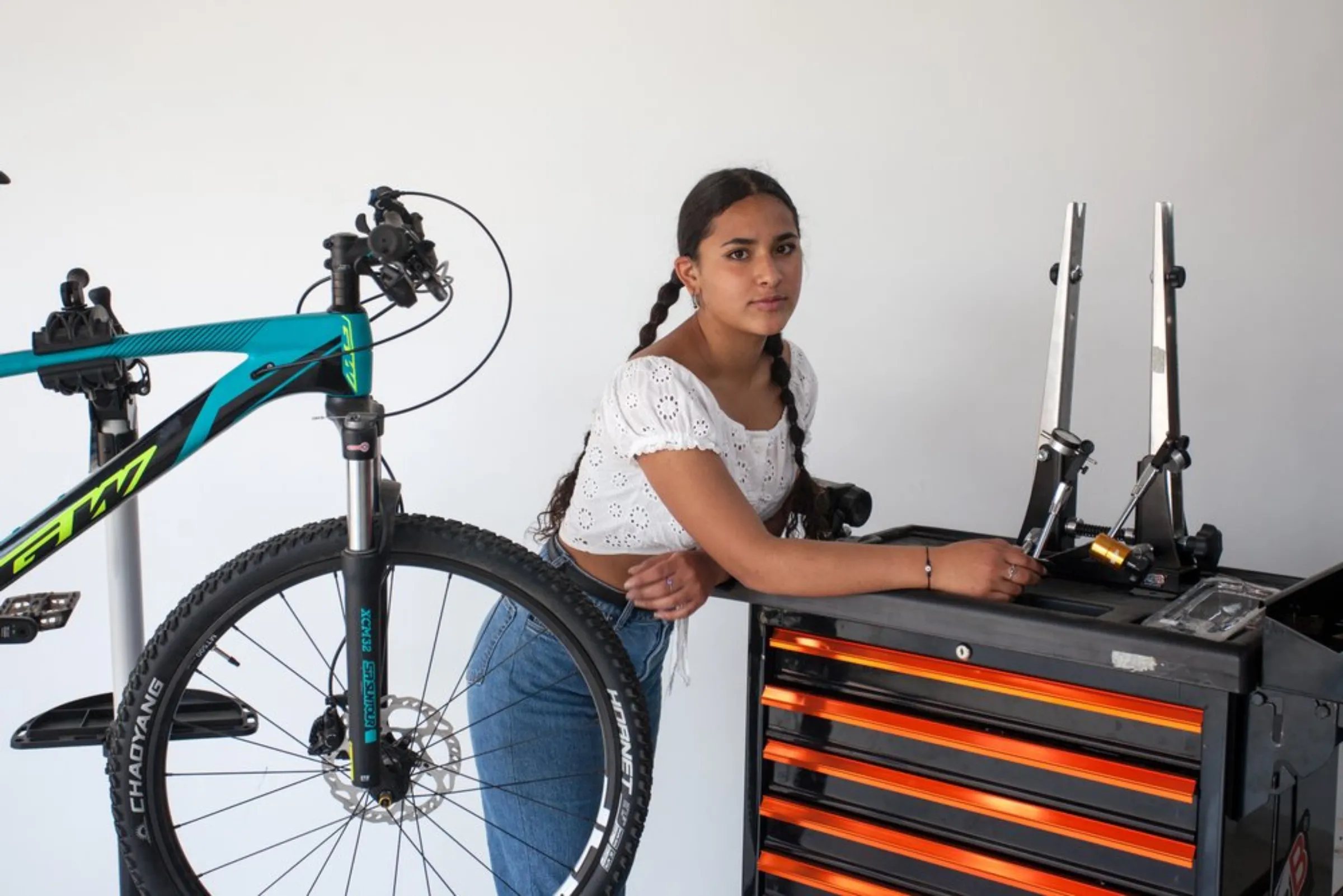 Isabella Vargas, 16, a student at “The Bike College”, a new public school in the poor neighbourhood of Bosa, stands with a bicycle and tools to repair it at the school in south Bogota, Colombia, April 22, 2021