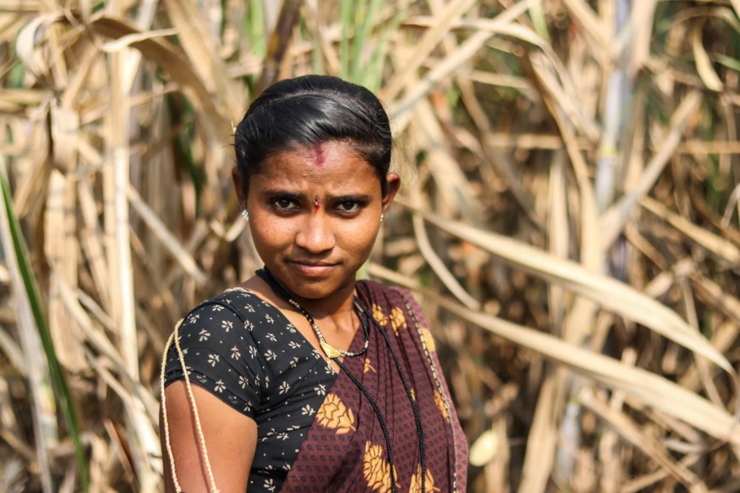 Moni Nave, a sugercane cutter in her early 20s poses for a picture in the sugarcane fields in Maharashtra’s Khochi village, India, which is over 600 kilometres (372 miles) from her village. December 17, 2022. Sanket Jain/Thomson Reuters Foundation