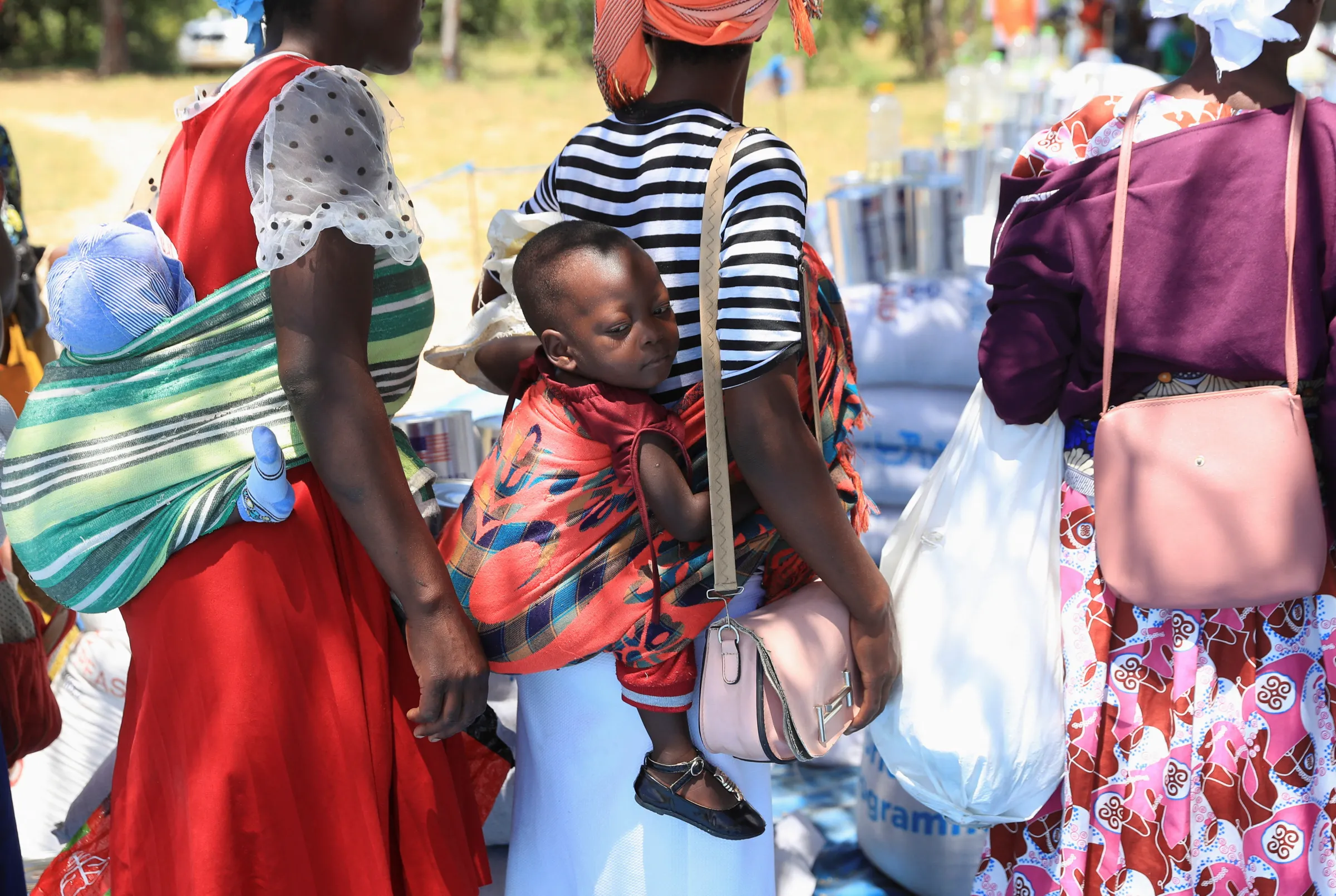 Women queue to collect their monthly allocations of food aid provided by the World Food Program (WFP) in Harare, Zimbabwe, March 16, 2024. REUTERS/Philimon Bulawayo