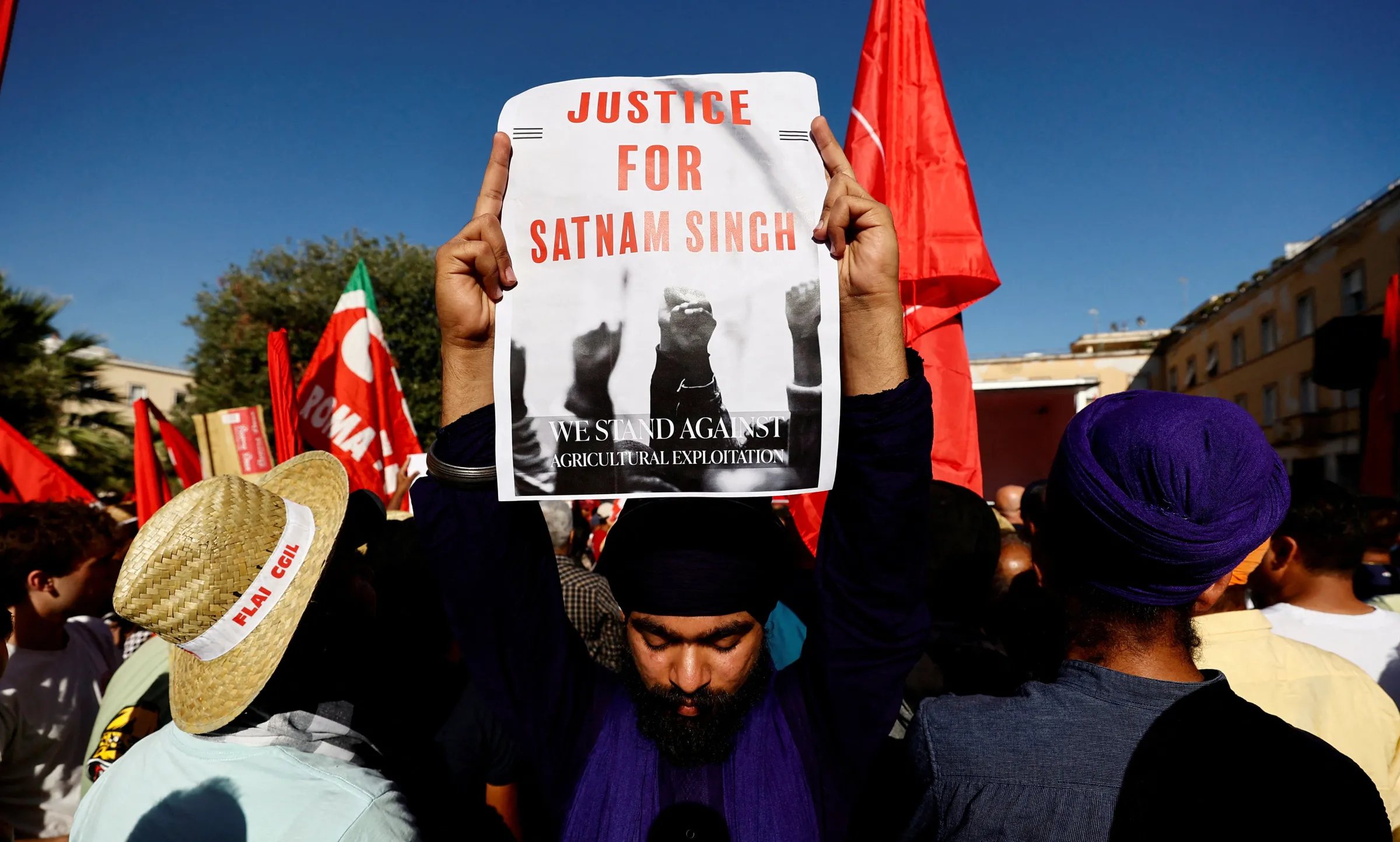 A demonstrator holds a placard that reads: 'Justice for Satnam Singh' during a protest following the death of an Indian farm labourer, Satnam Singh in Latina, Italy June 22, 2024. REUTERS/Stringer