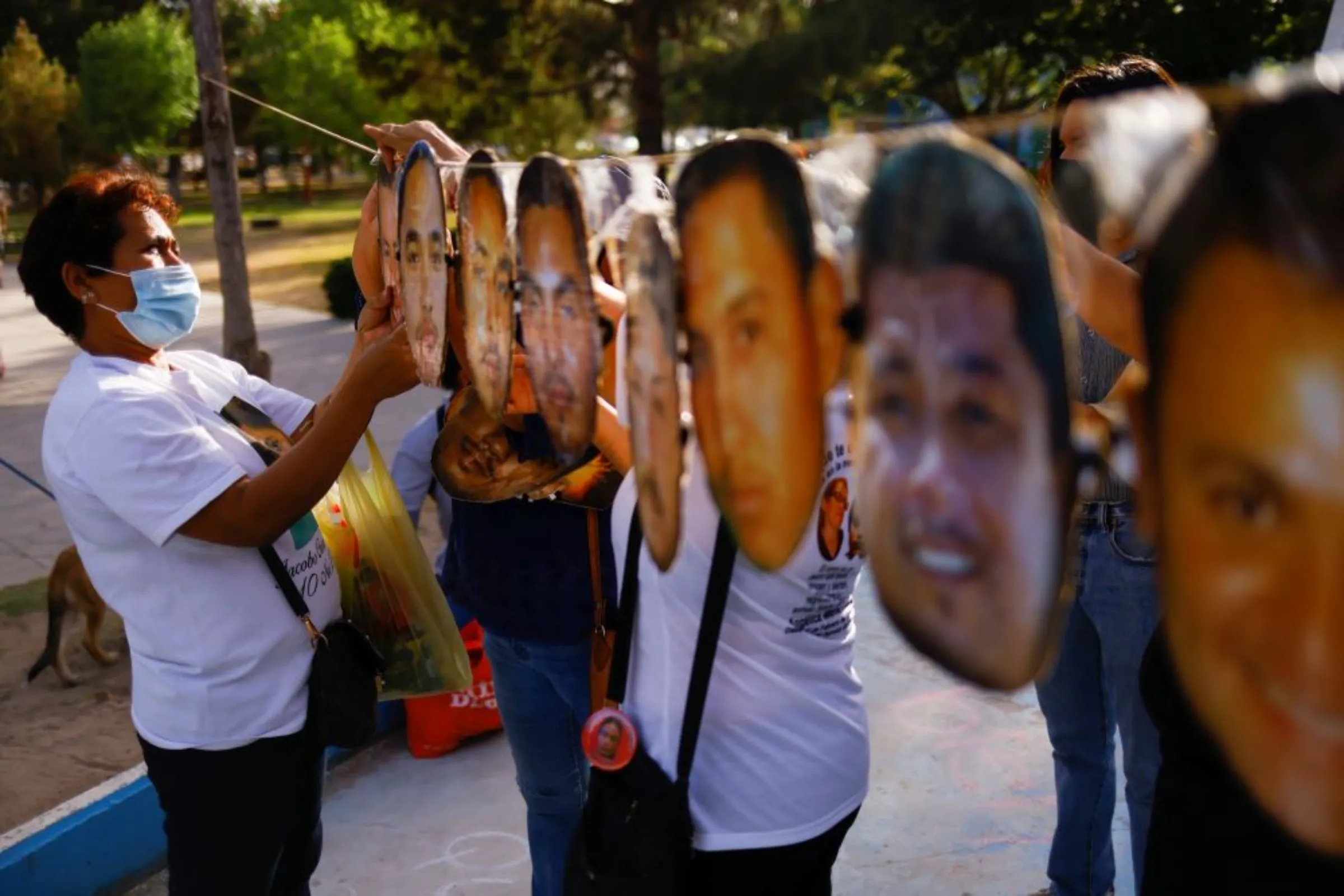 Mothers places impressions of the faces of missing persons during a protest ahead of Mother's Day in Ciudad Juarez, Mexico May 8, 2022