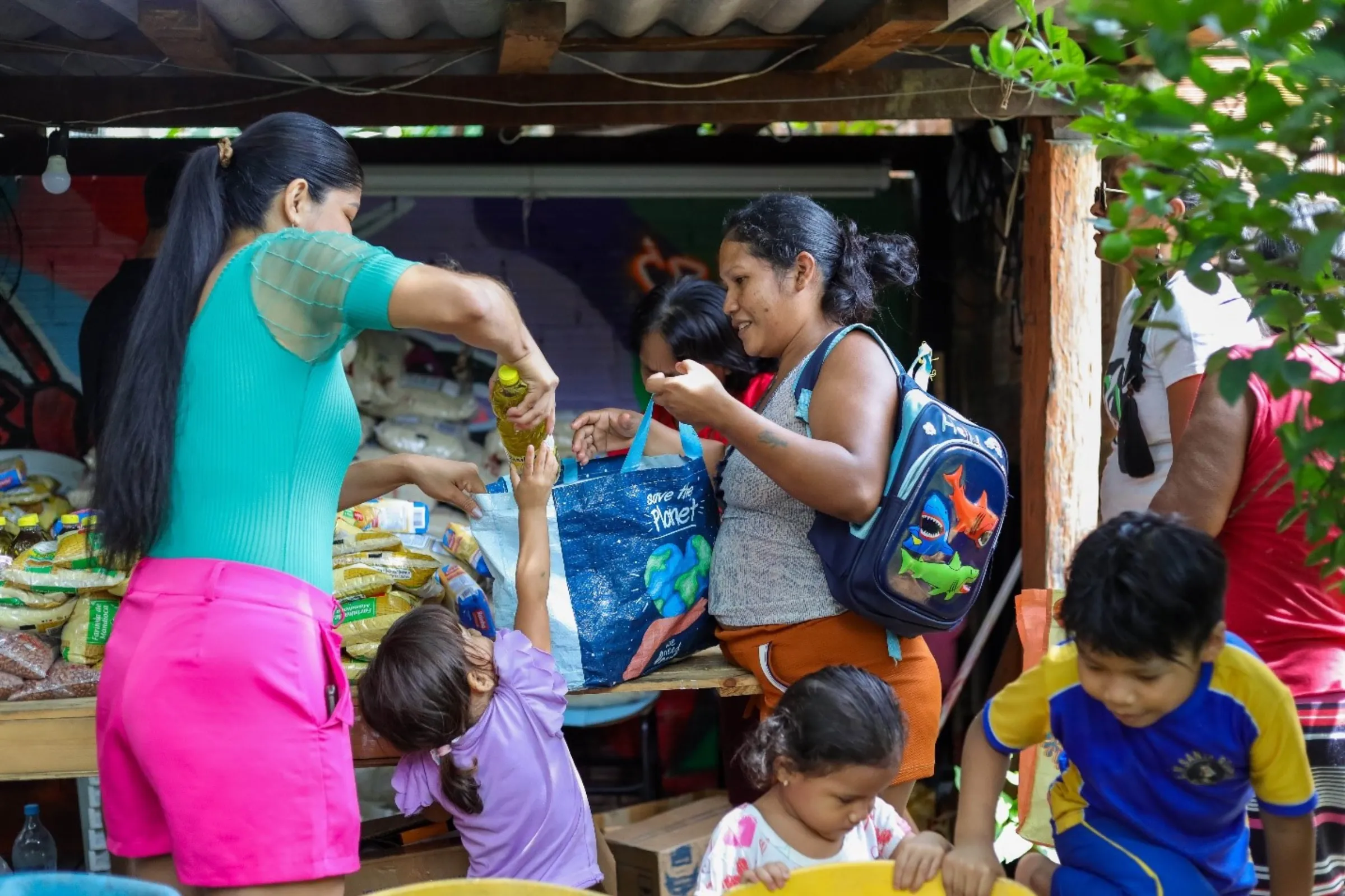 Women get food in the headquarters from Ateliê Derequine in Manaus, Brazil, March 12, 2025. Nathalie Brasil/Thomson Reuters Foundation