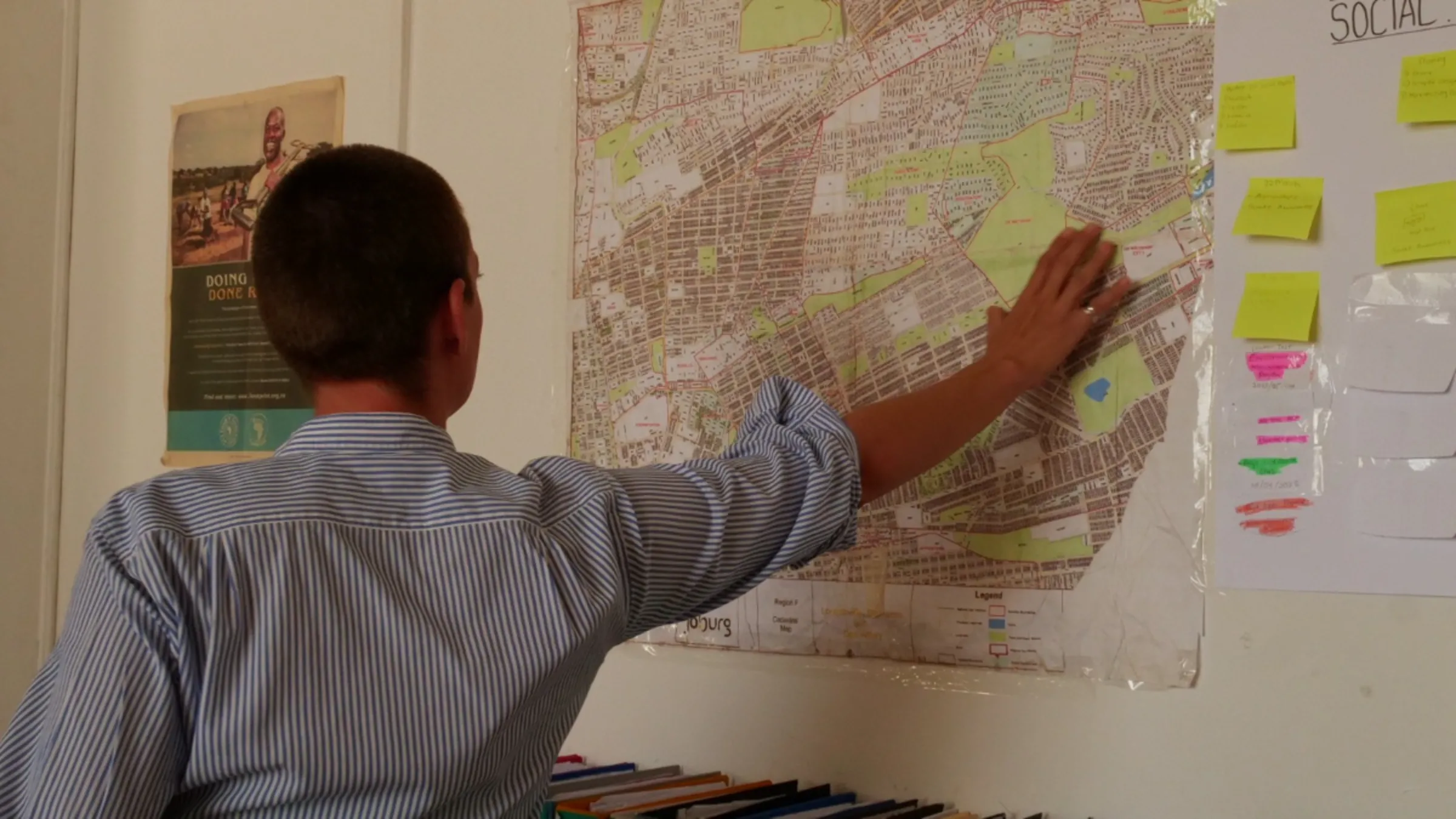 Romy Stander, the founder of Water for the Future, points to a map which shows where the Jukskei River flows through the city in Johannesburg, South Africa, May 10, 2023. Thomson Reuters Foundation/ Kim Harrisberg