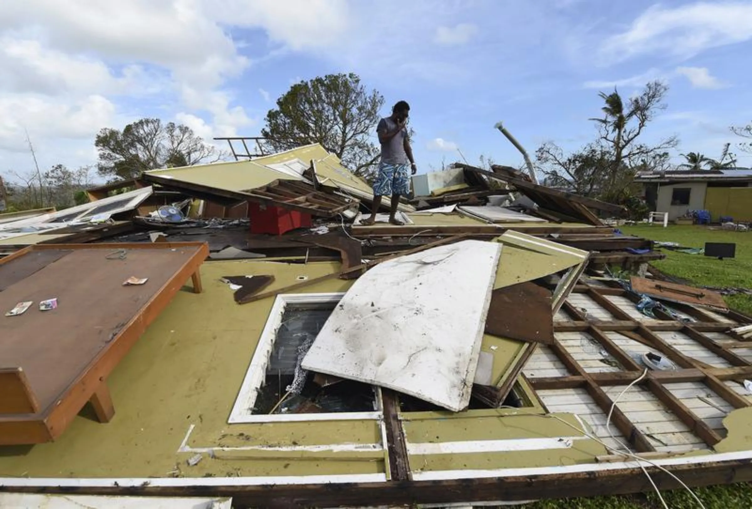 Local resident Adrian Banga looks at his home destroyed by Cyclone Pam in Port Vila, the capital city of the Pacific island nation of Vanuatu March 16, 2015. Reuters/File Photo