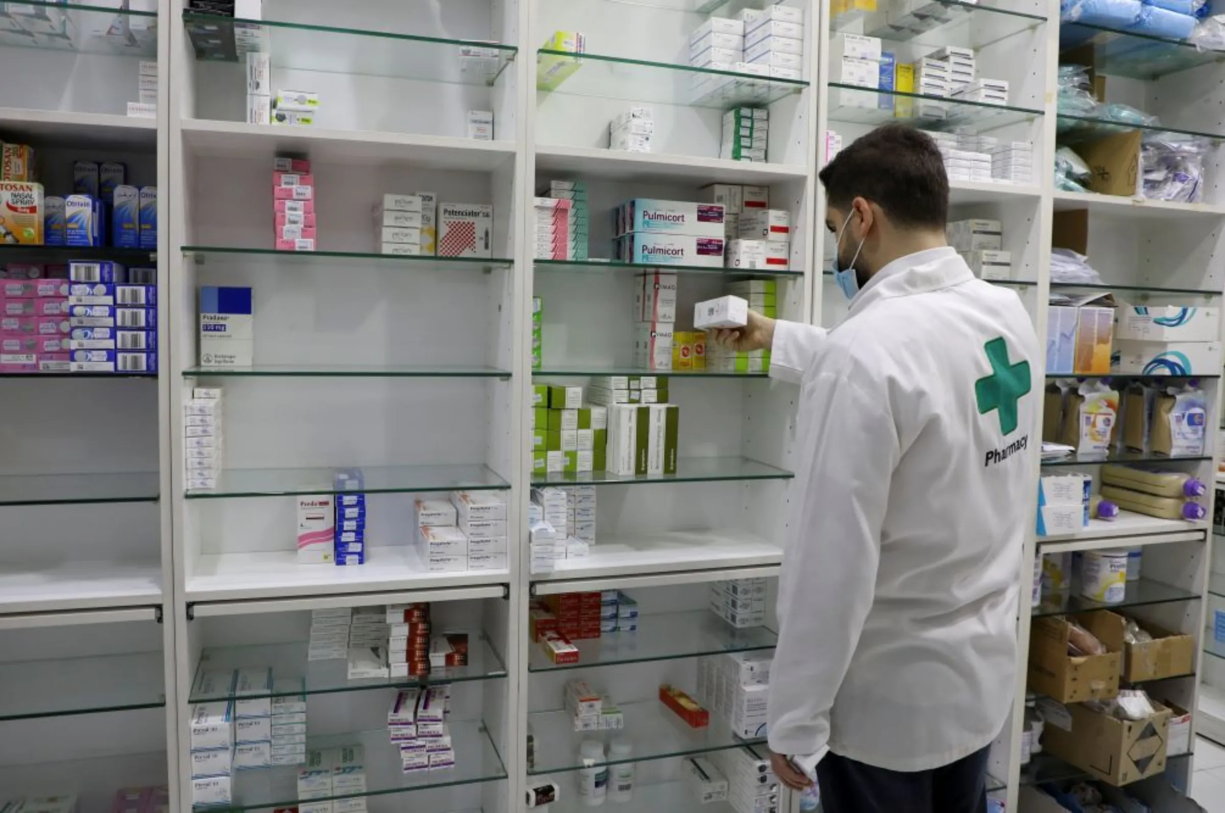 A pharmacy employee holds a box of medication in Beirut, Lebanon May 28, 2021