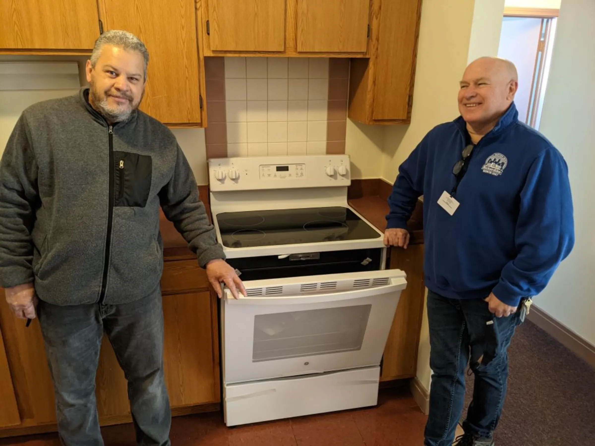 Employees install an electric stove in a building in Chicago in 2021. Bickerdike Redevelopment Corporation/Handout via Thomson Reuters Foundation