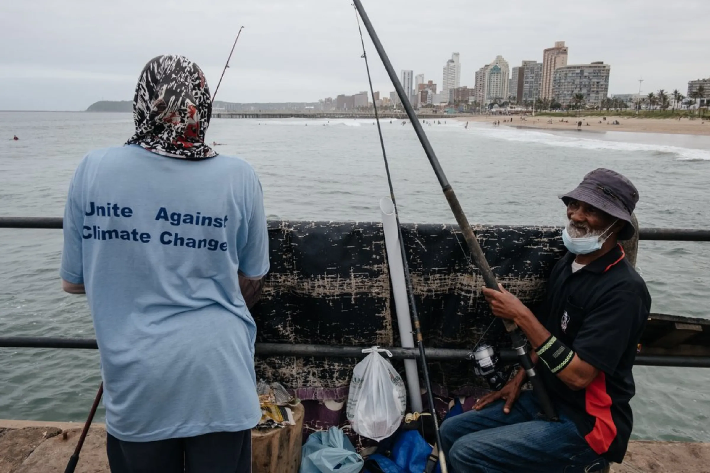 Subsistence anglers cast lines at Snakepark Pier on the beachfront in Durban, South Africa, April 1, 2021