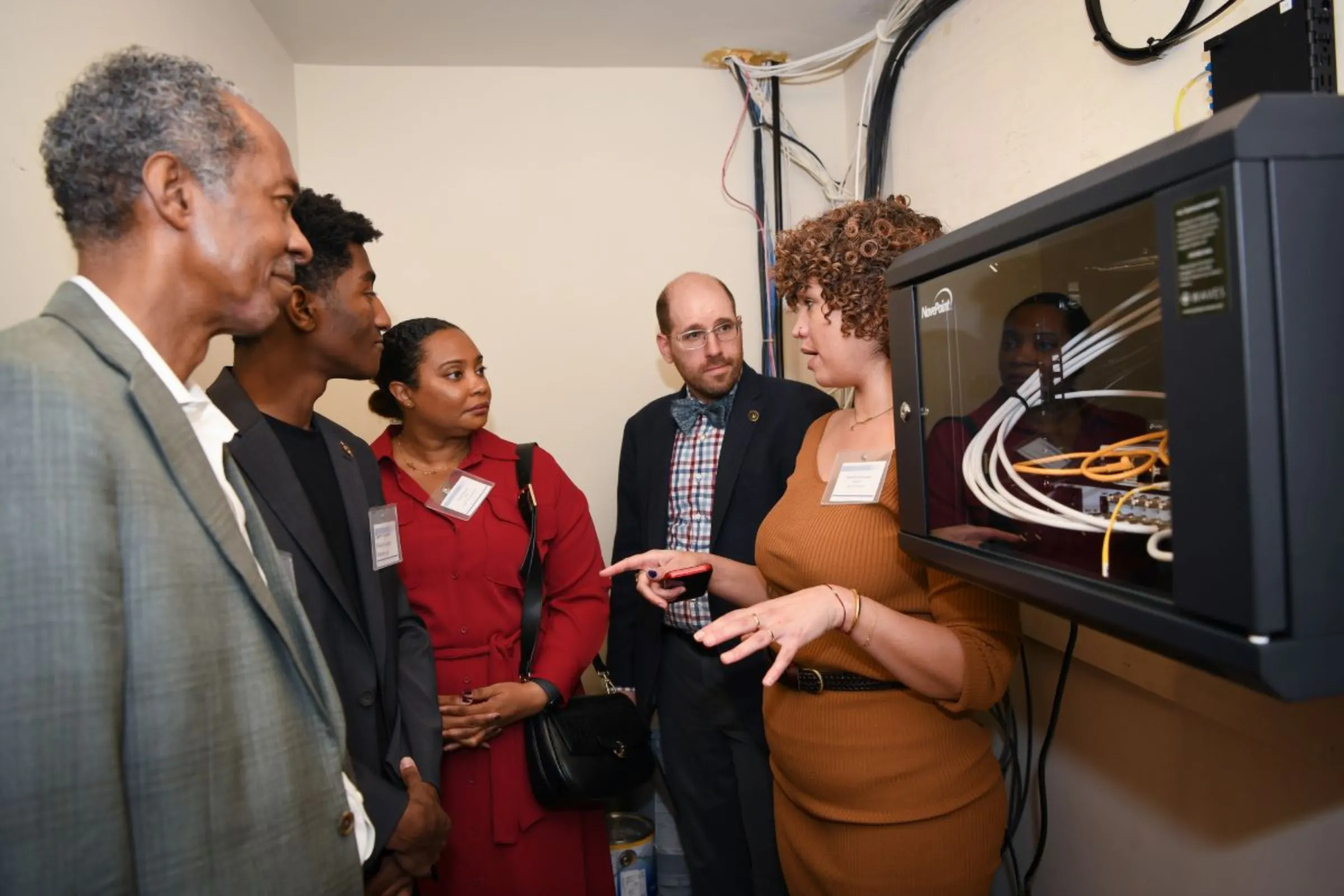 Samantha Musgrave, right, director of NGO Project Waves, addresses local and federal officials and others about a project to bring free-high speed home Internet service to an affordable senior housing development in East Baltimore in October 2022