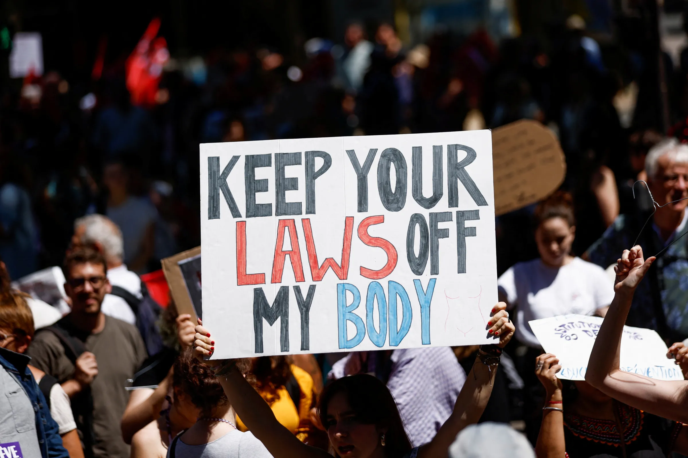 A protester holds a placard as people gather for a rally in support of abortion rights