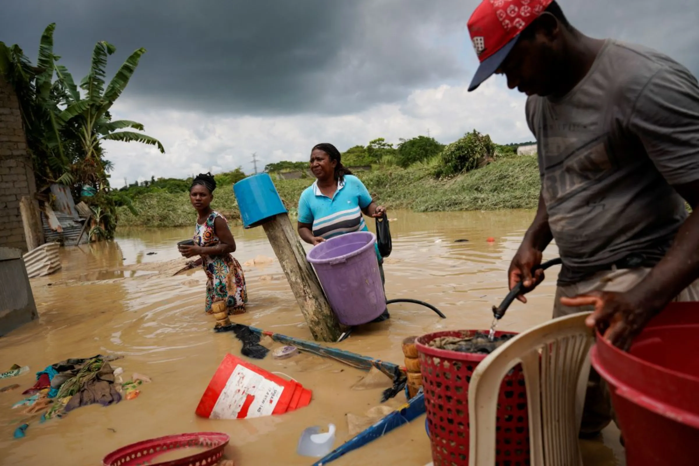 People try to salvage things after their homes and neighbourhood were flooded due to heavy rains, in Esmeraldas, Ecuador June 5, 2023