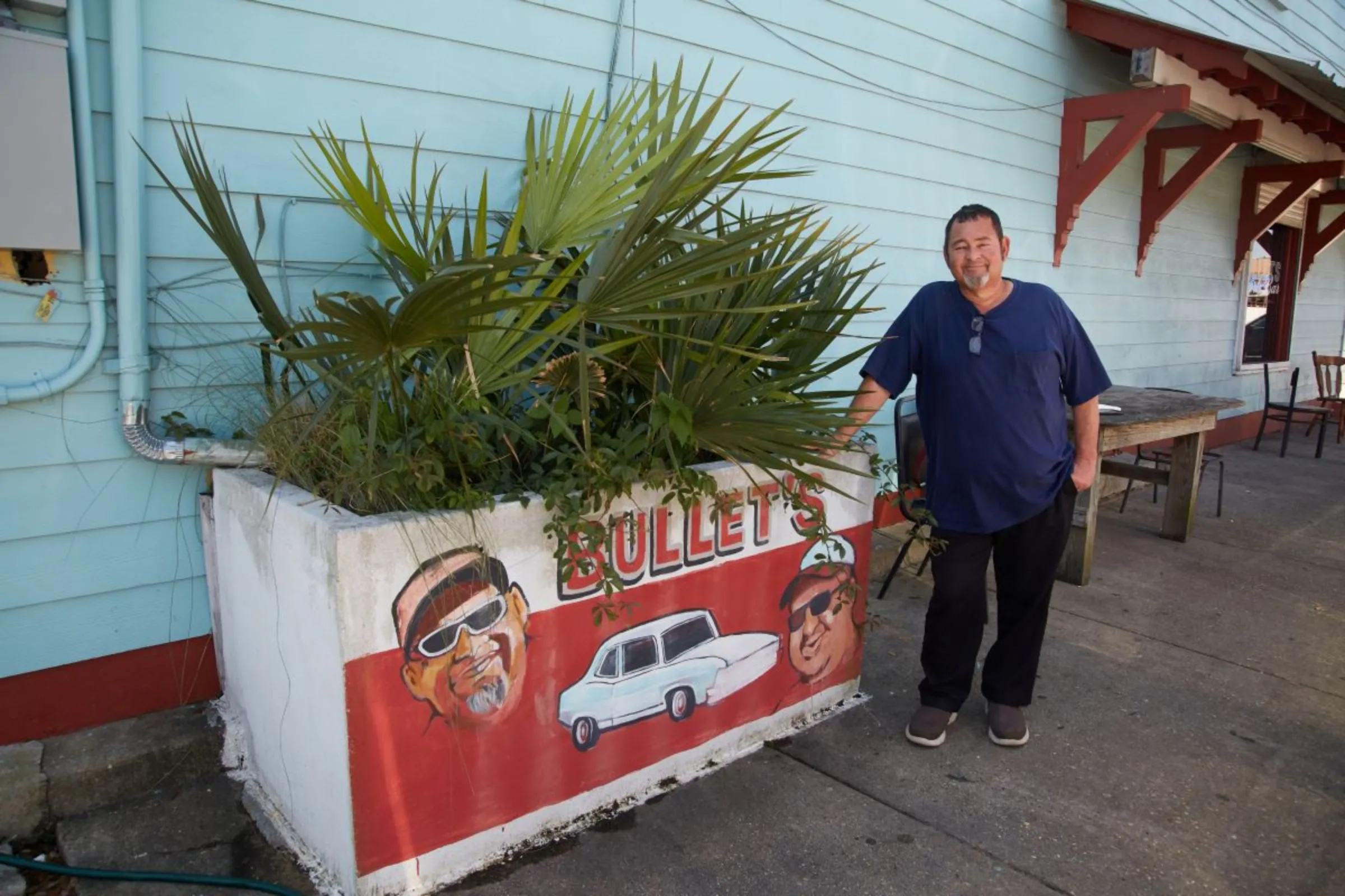 Rollin Garcia, owner of Bullet’s Sports Bar, poses next to a planter box outside his bar in New Orleans, Louisiana, USA, April 19, 2023