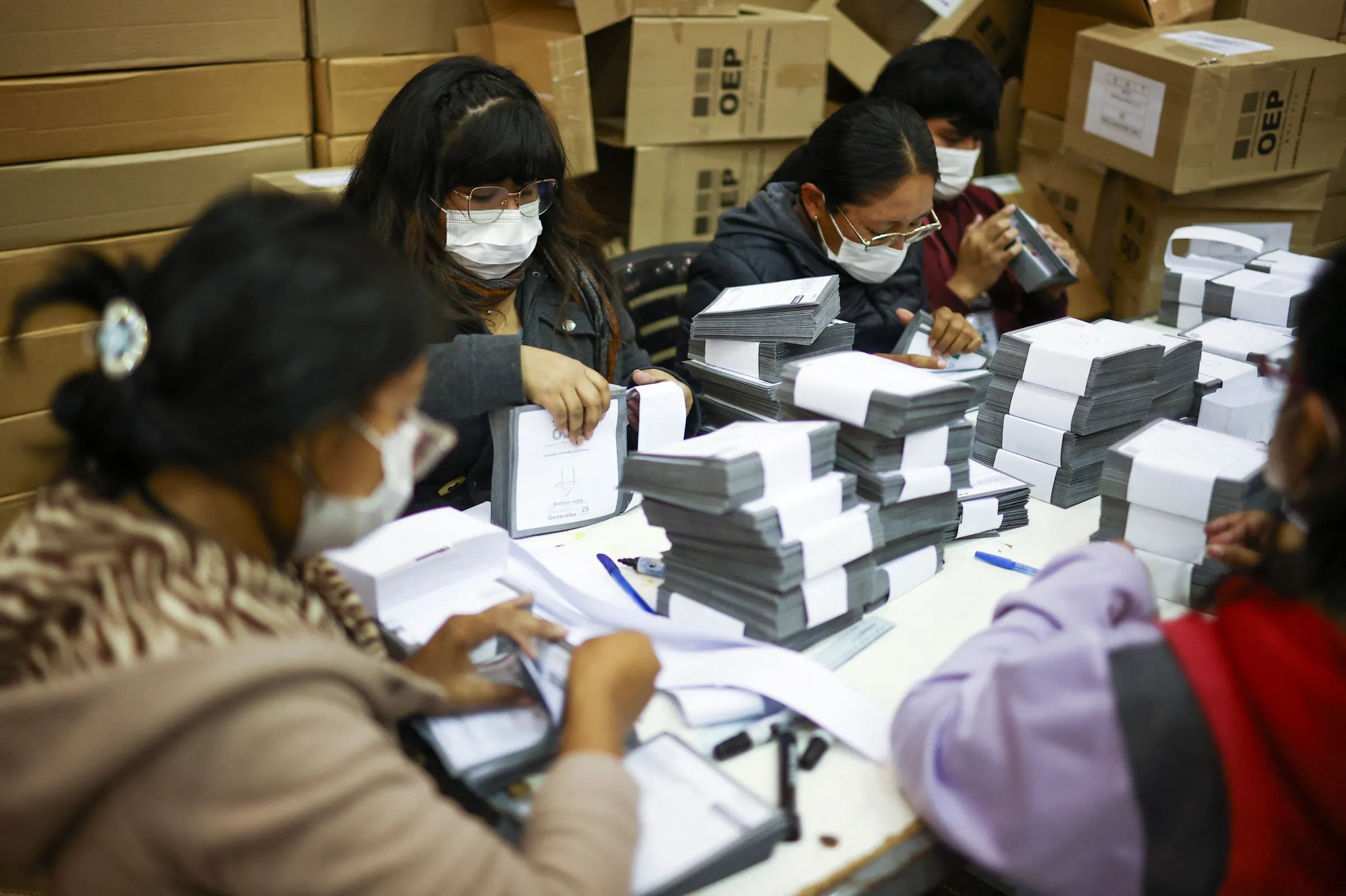 Electoral workers handle ballots ahead of the general election to be held on August 17, in Cochabamba, Bolivia August 11, 2025. REUTERS/Agustin Marcarian