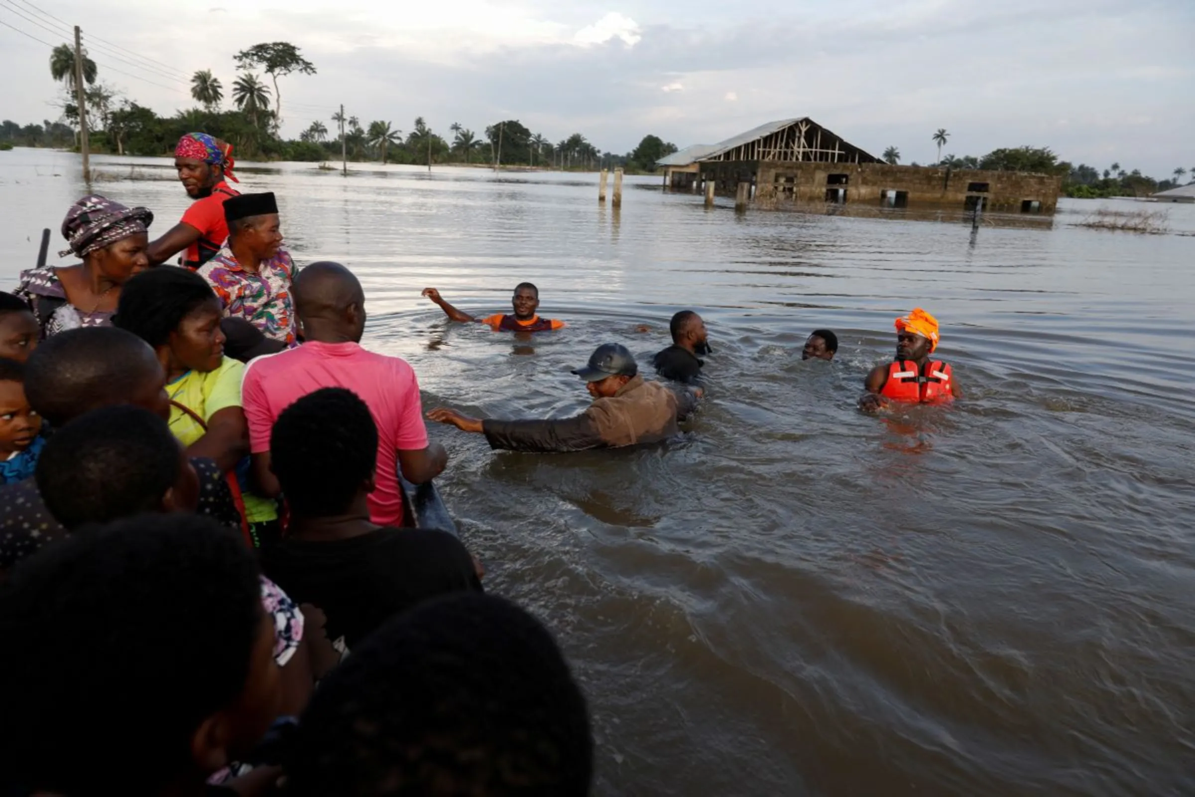 Residents wade through chest-deep flood water following a massive flood in Obagi community, Rivers state, Nigeria October 22, 2022. REUTERS/Temilade Adelaja