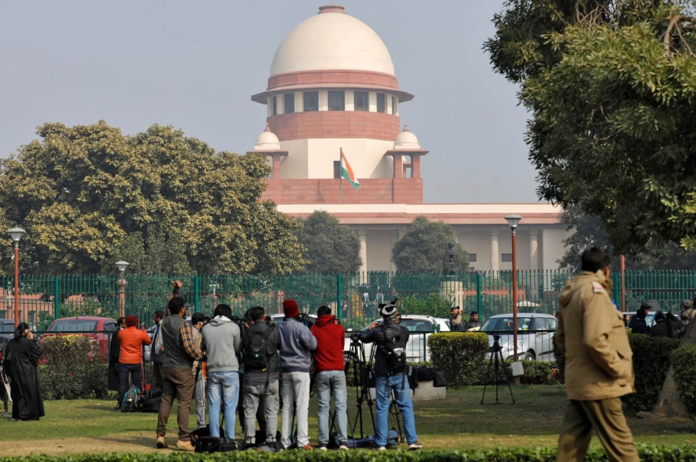 Television journalists are seen outside the premises of the Supreme Court in New Delhi, India, January 22, 2020