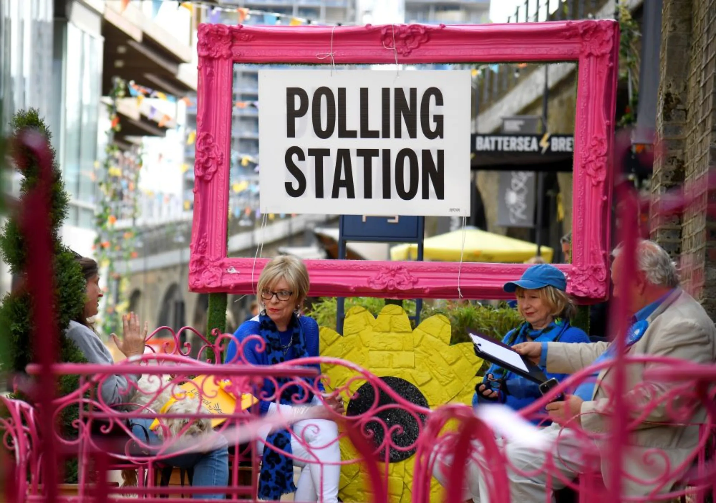 Volunteers wait to record voters' intentions at a new polling station at The Turbine Theatre in the Nine Elms ward of the borough of Wandsworth on the day of the local elections, in London, Britain, May 5, 2022