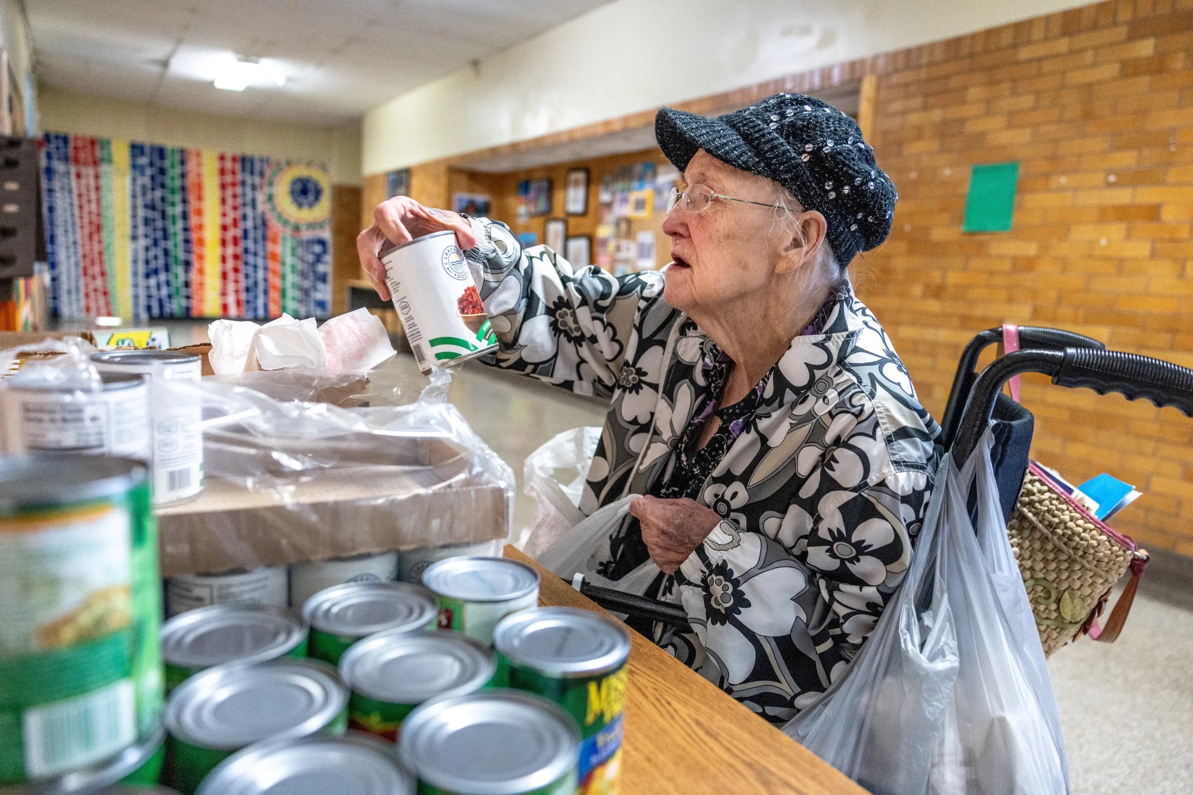 A woman collects food from a pantry supported by Trinity's Table at the Roosevelt Community Center, in Charleston, West Virginia, U.S., March 19, 2025. REUTERS/Evelyn Hockstein