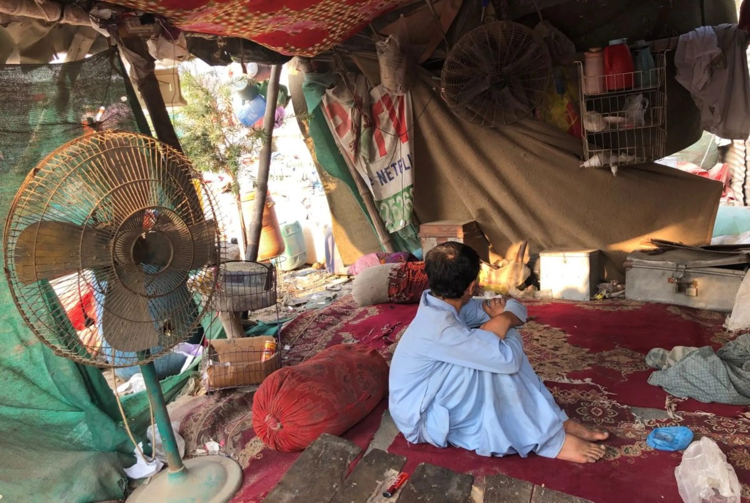 A 15-year-old undocumented rag picker is pictured in his boss’s junkyard, behind Al-Asif Square, Karachi, Pakistan, November 8, 2023