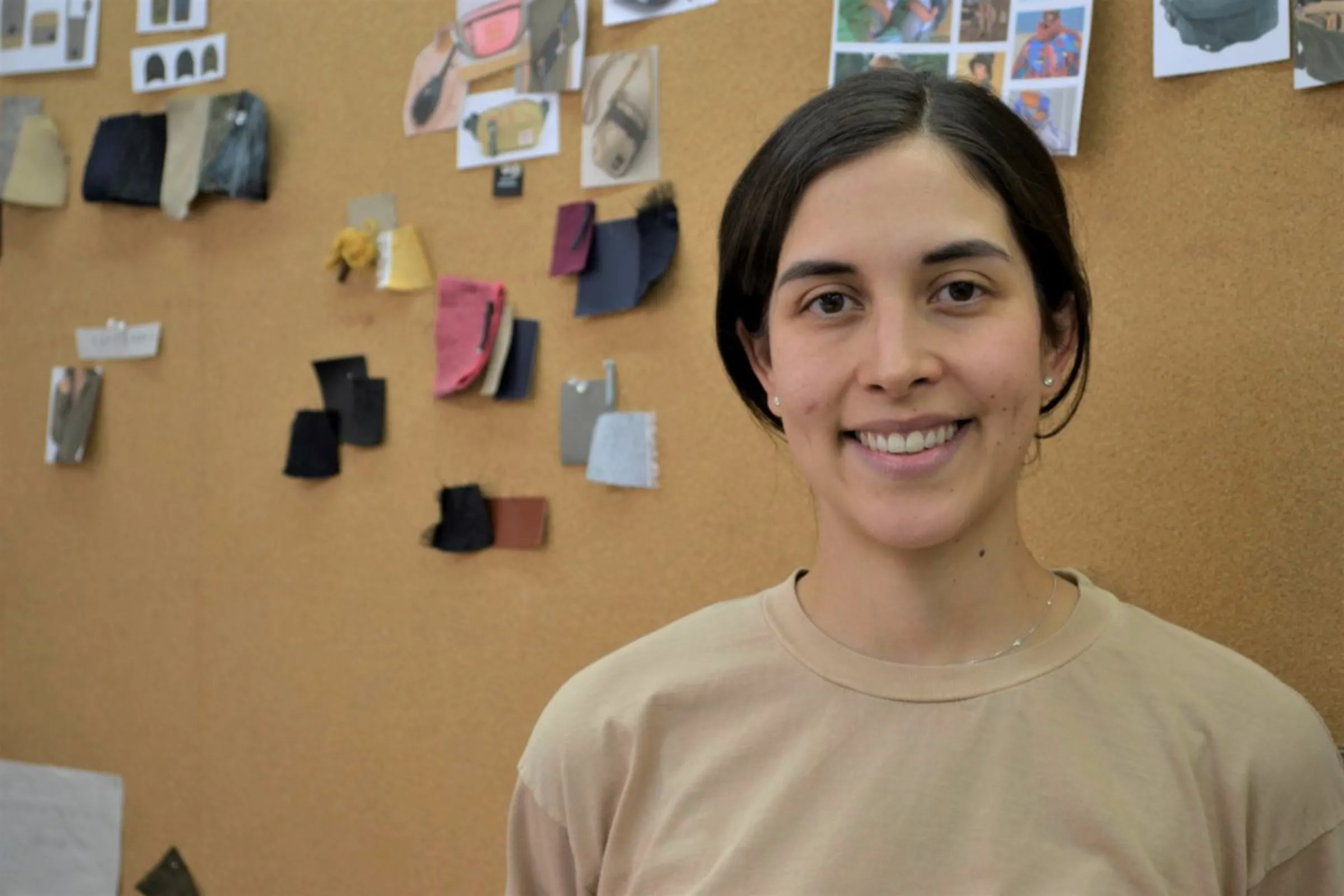 Designer Regina Soto poses next to a mood board from the offices on Someone Somewhere in Mexico City, April 24, 2023. Thomson Reuters Foundation/Diana Baptista