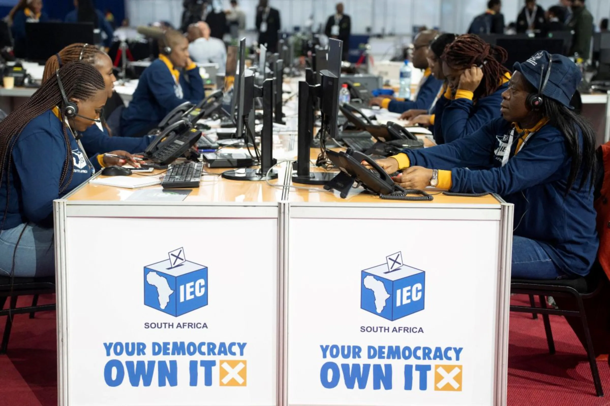 Workers from the Independent Electoral Commission work at their desks at the national results operations centre as they await the conclusion of the voting process, in Midrand, South Africa May 29, 2024. REUTERS/Ihsaan Haffejee