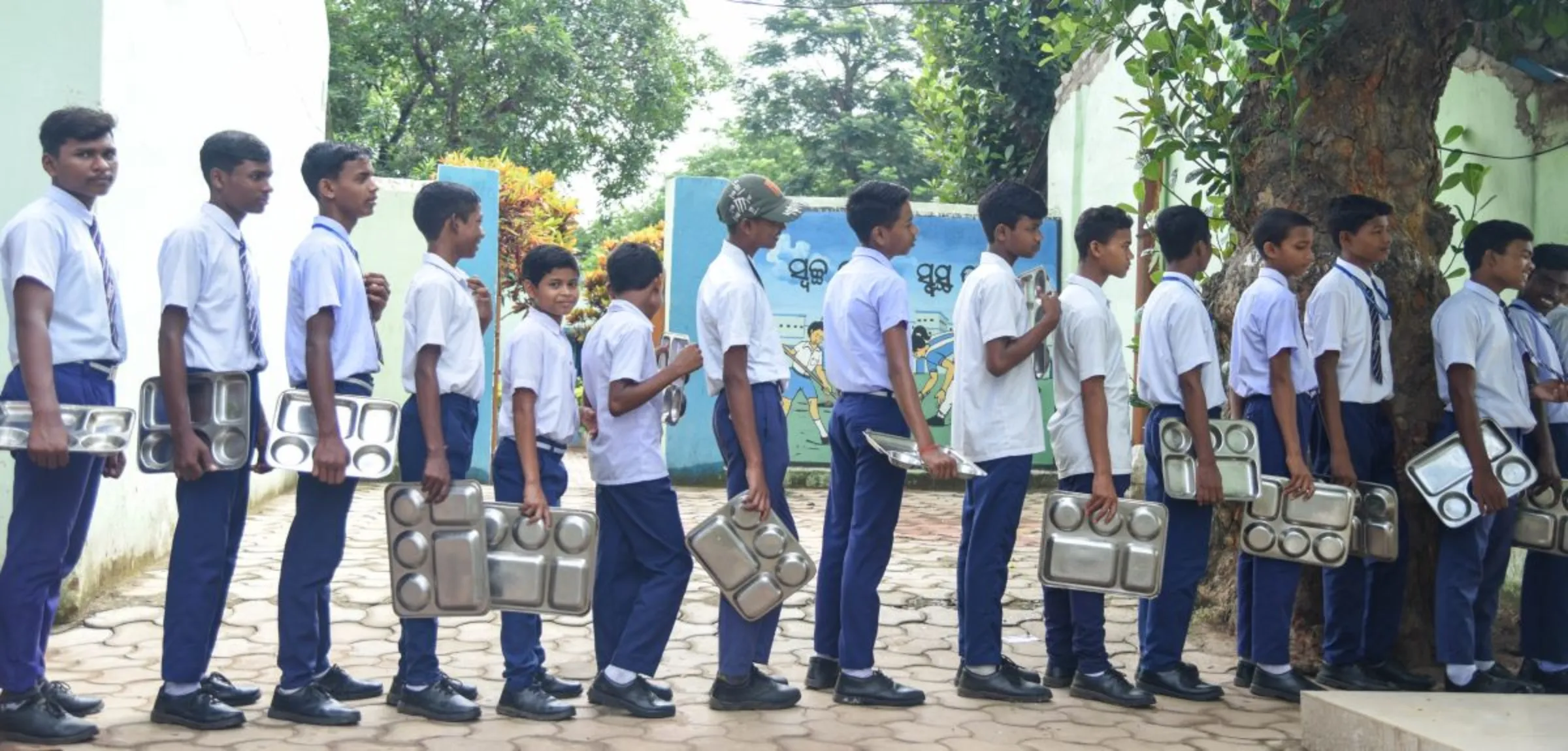 Students queue up for their meal at a state-run residential school in Keonjhar, India, on July 13, 2023. Thomson Reuters Foundation/Tanmoy Bhaduri