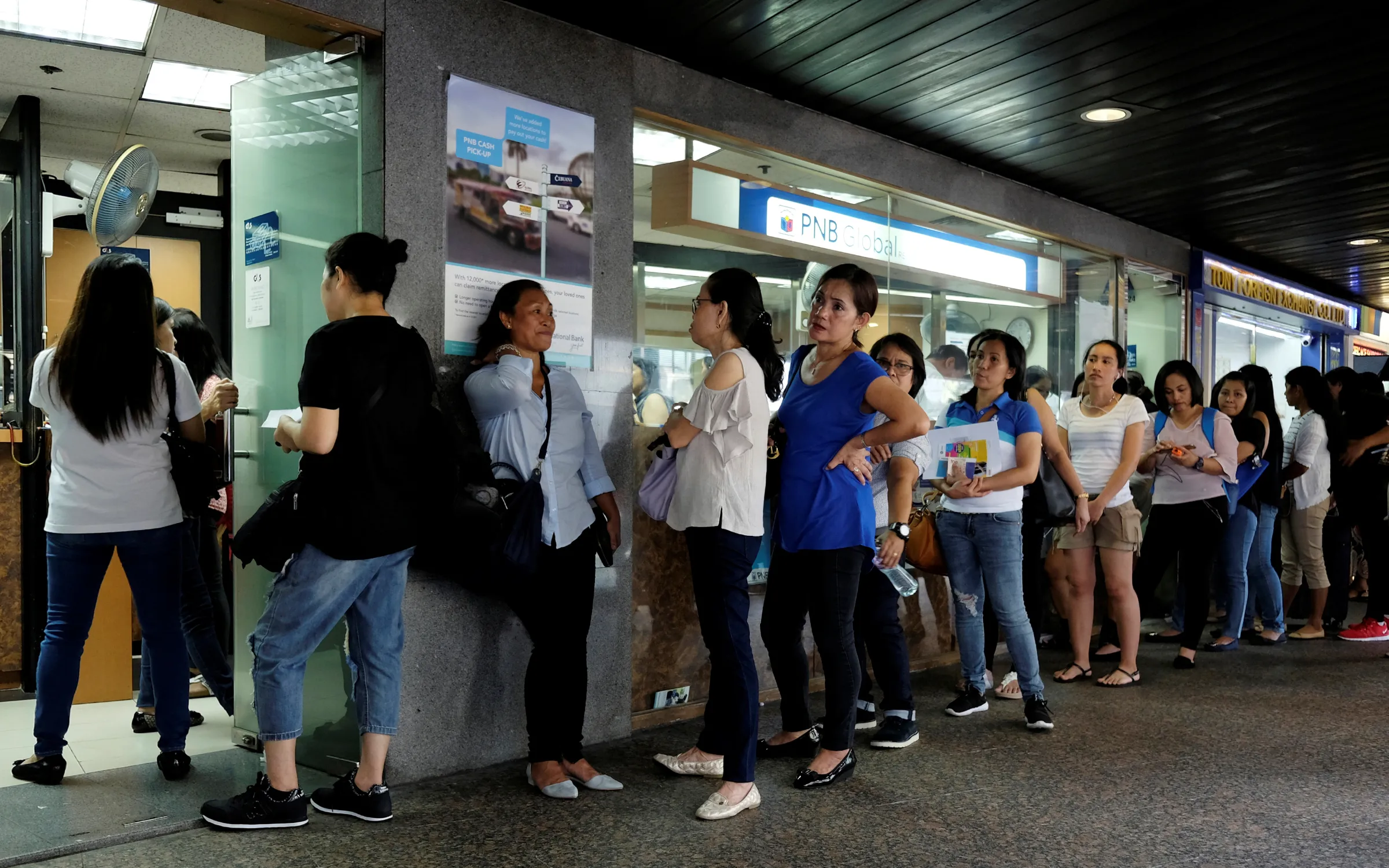 Domestic helpers line up for remittance services at the financial Central district in Hong Kong, China September 2, 2018. REUTERS/Bobby Yip