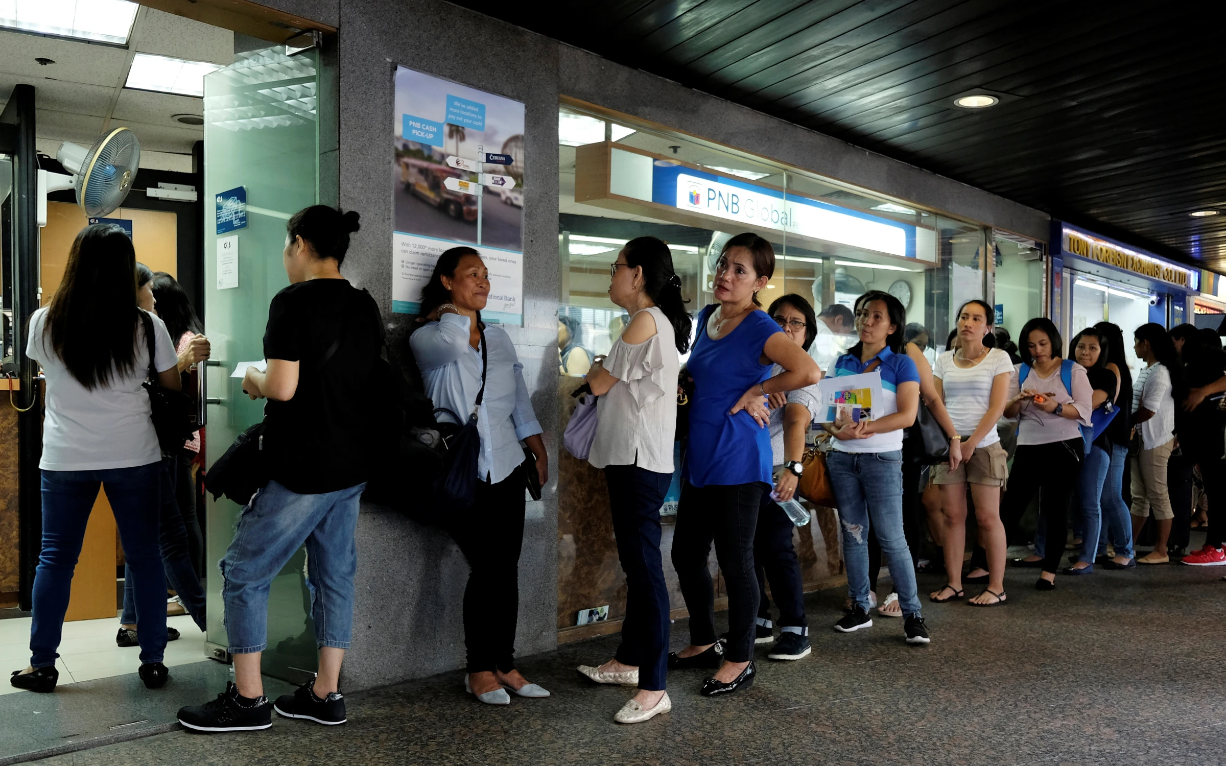Domestic helpers line up for remittance services at the financial Central district in Hong Kong, China September 2, 2018. REUTERS/Bobby Yip