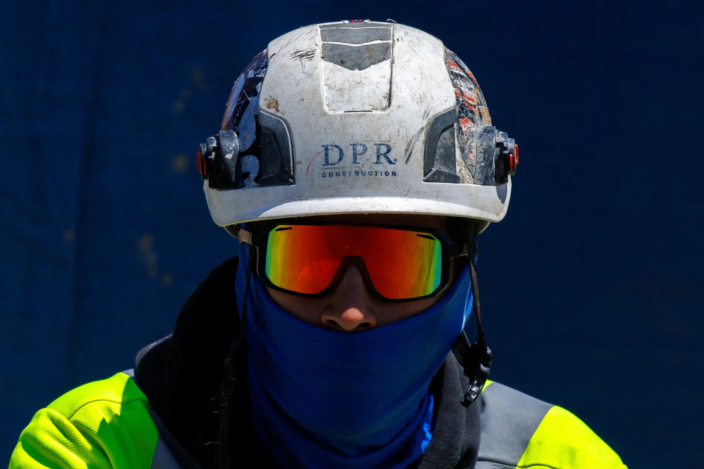 A construction worker keeps covered up from the sun as workers deal with hot weather while building a large office complex in the biotech sector of San Diego, California, U.S., July 2, 2024. REUTERS/Mike Blake