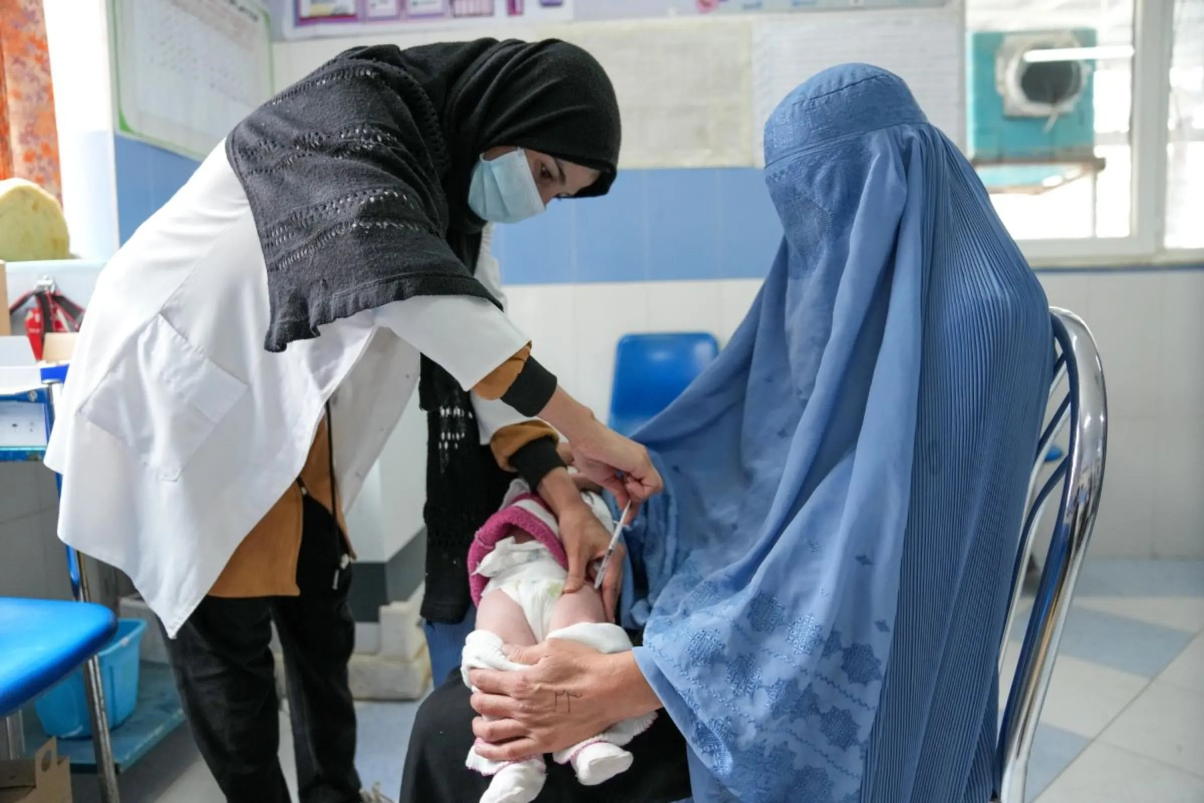 A nurse vaccinates a baby at a clinic in Herat, Afghanistan, in November 2022.